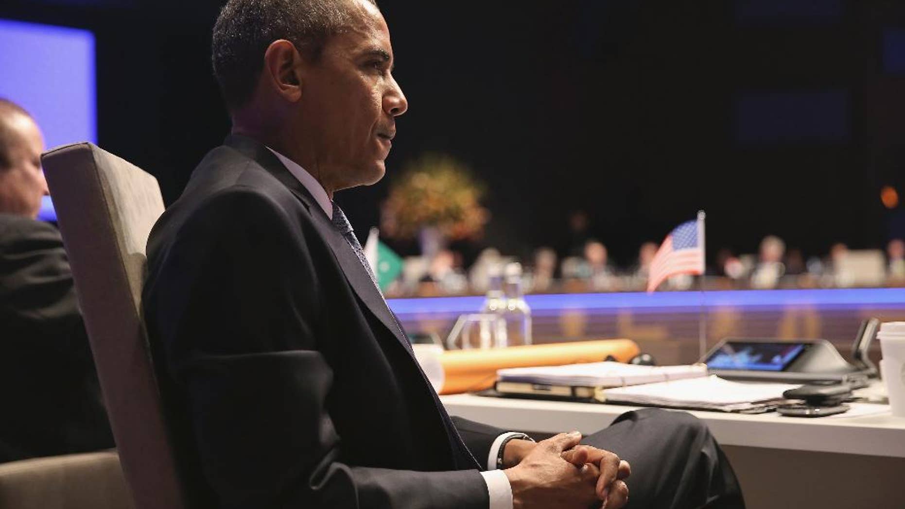 U.S. President Barack Obama attends the opening session of the Nuclear Summit in The Hague, the Netherlands, on Monday, March 24, 2014. President Barack Obama gathered with world leaders in a day of delicate diplomacy, as he sought to rally the international community Monday around efforts to isolate Russia following its incursion into Ukraine. Nuclear terrorism was the official topic as Obama and other world leaders streamed in to a convention center in The Hague for a two-day nuclear summit. But the real focus was on a hurriedly scheduled meeting of the Group of Seven industrialized economies to address the crisis in Ukraine on the sidelines of the nuclear summit. (AP Photo/Sean Gallup, POOL)