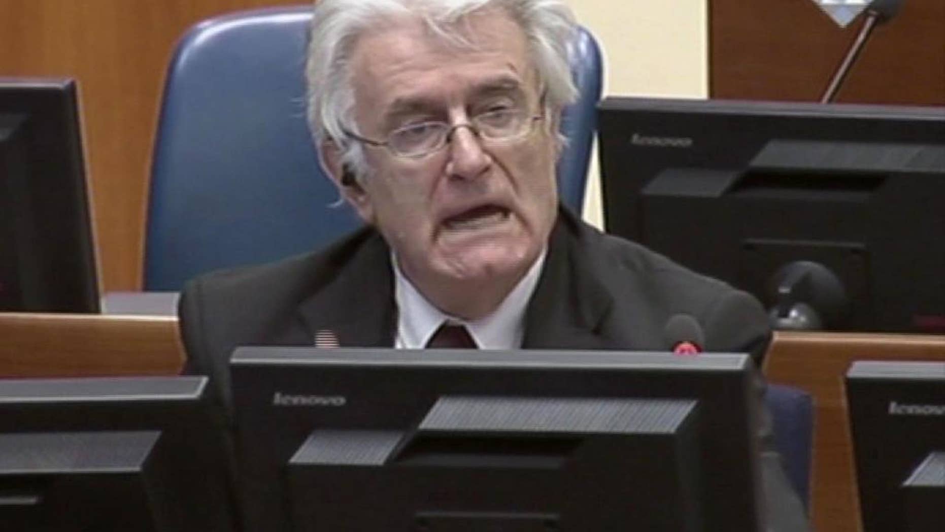 Former Bosnian Serb leader Radovan Karadzic addresses the court of the International Criminal Tribunal for the former Yugoslavia in The Hague Netherlands in this image taken from TV, Wednesday Oct. 1, 2014. Karadzic insisted Wednesday that United Nations prosecutors do not have "a shred of evidence" linking him to atrocities throughout the Bosnian war, and accused them of putting the entire Serb people on trial. In an 874-page written brief summarizing his defense, Karadzic said he should not be convicted by the U.N.'s Yugoslav war crimes tribunal, but acknowledged that, as wartime leader of the breakaway Serb entity in Bosnia, he "bears moral responsibility for any crimes committed by citizens and forces of Republika Srpska." (AP Photo/ICTY via Associated Press Television)