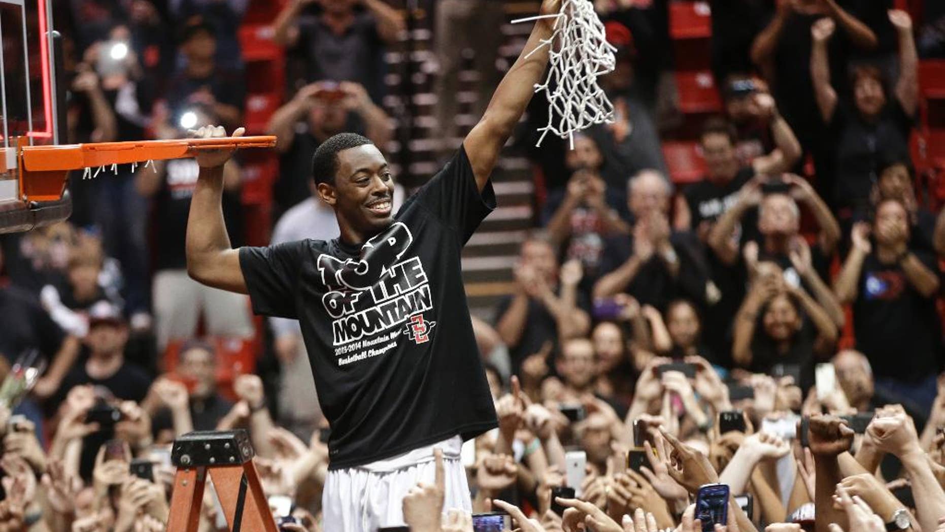 San Diego State's Xavier Thames holds up a cut net after San Diego State defeated New Mexico 51-48 to win the Mountain West Conference title, in an NCAA college basketball game Saturday, March 8, 2014, in San Diego. (AP Photo/Lenny Ignelzi)