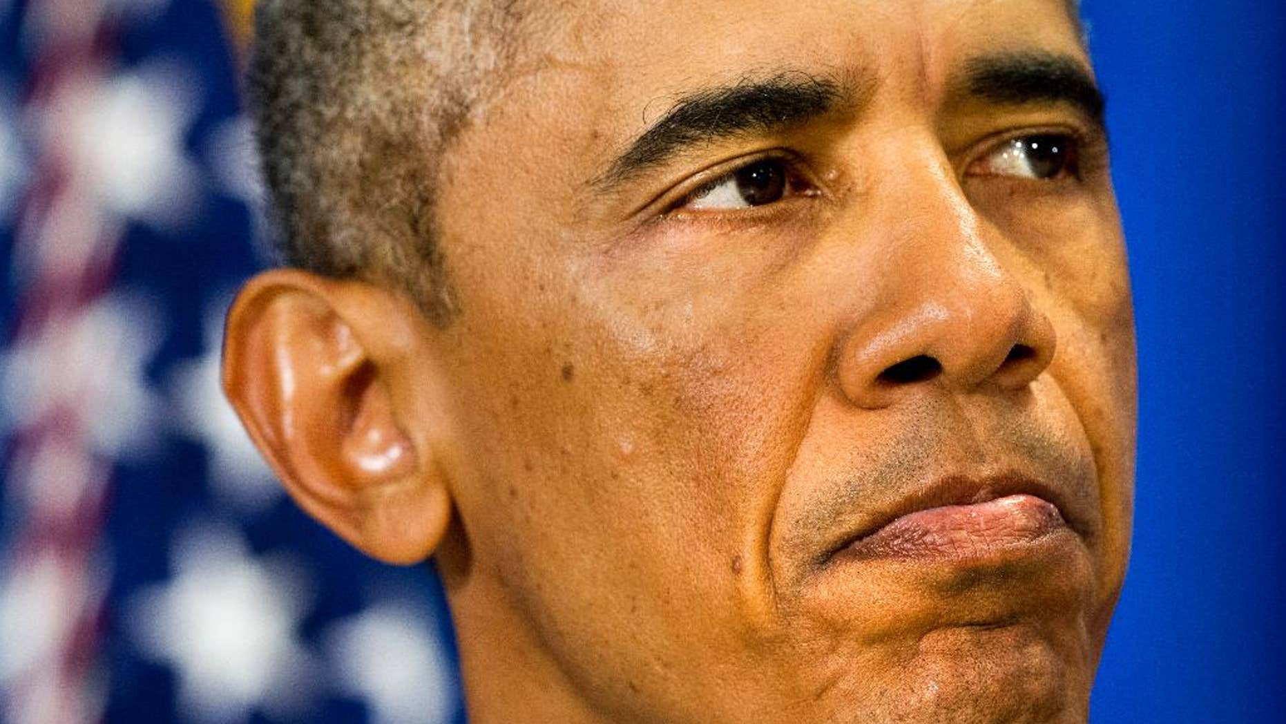 U.S. President Barack Obama pauses as he speaks about the killing of journalist James Foley in Syria during a statement in Edgartown, Mass., Wednesday, Aug. 20, 2014. The president said the U.S. will continue to confront Islamic State extremists despite Foley's brutal murder. Obama said he spoke Wednesday with Foley's family and offered condolences. (AP Photo/Jacquelyn Martin)
