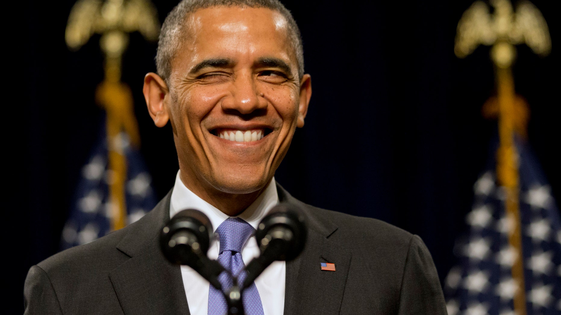 President Barack Obama winks as he is welcomed before speaking to the House Democratic Issues Conference in Cambridge, Md., Friday, Feb. 14, 2014. The president said top priorities for Congress should be increasing the minimum wage and reforming immigration. Obama told a House Democratic retreat Friday that the party needs to stand up for the American dream of getting ahead. (AP Photo/Jacquelyn Martin)