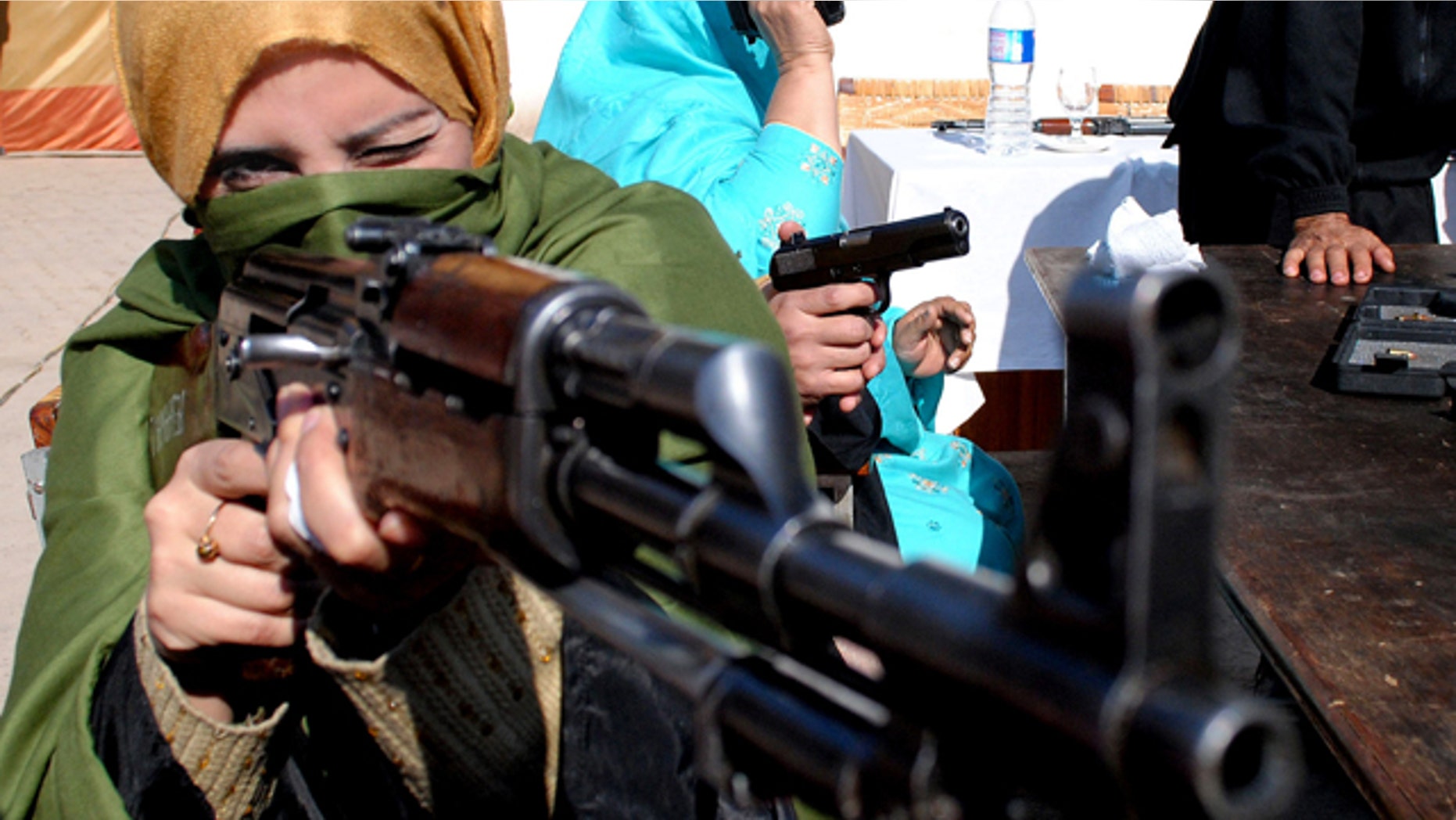 Jan. 27, 2015: A Pakistani teacher holds an weapon during a two-day training session by the police in Peshawar. (AP Photo/Mohammad Sajjad)