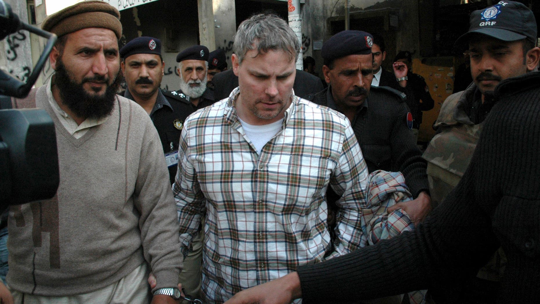 Jan. 28, 2011: Pakistani security officials escort Raymond Allen Davis, center, to a local court in Lahore, Pakistan. The Associated Press has learned that Davis, an American jailed in Pakistan after the fatal shooting of two armed men, was secretly working for the CIA.