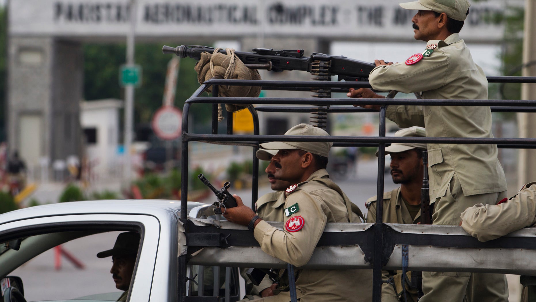 Aug. 16, 2012: Pakistani security personnel guard the main entrance of Pakistan air force base in Kamra, about 50 miles (85 kilometers) northwest of Islamabad, Pakistan.