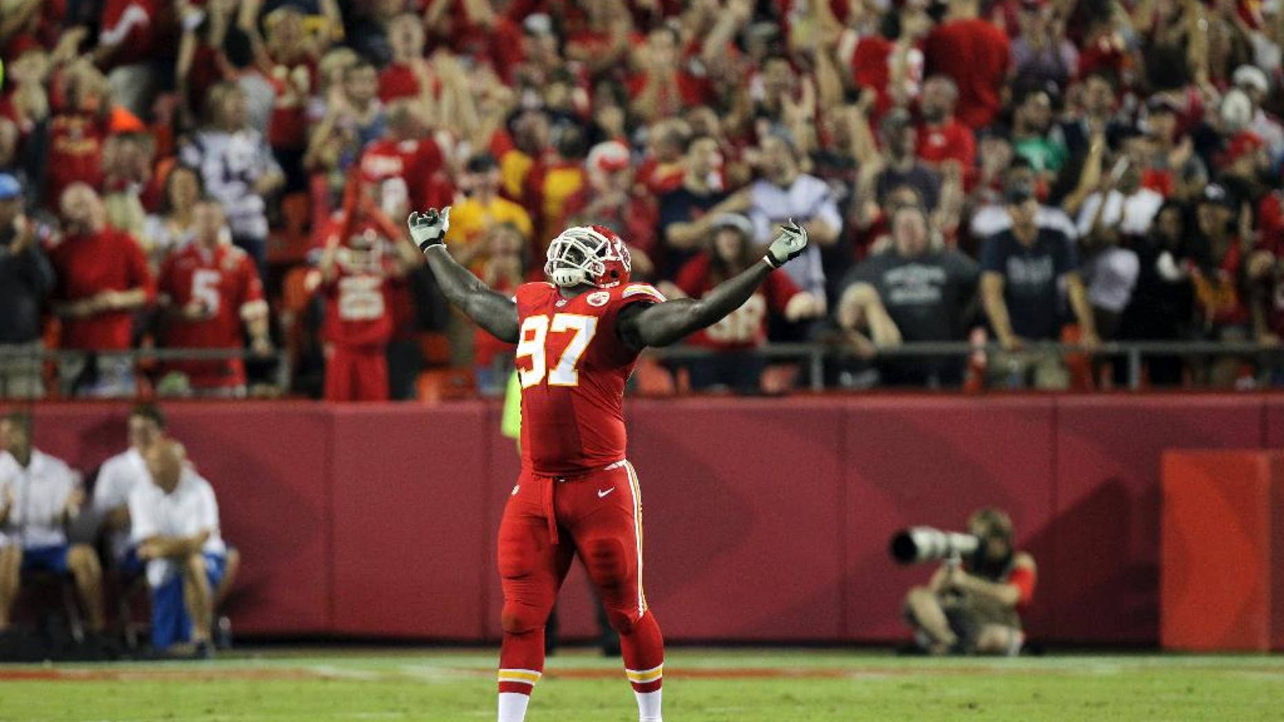 Kansas City Chiefs defensive end Allen Bailey celebrates after teammate Sean Smith intercepted a pass and ran it back 34-yards during the third quarter of an NFL football game against the New England Patriots, Monday, Sept. 29, 2014, in Kansas City, Mo. (AP Photo/Ed Zurga)