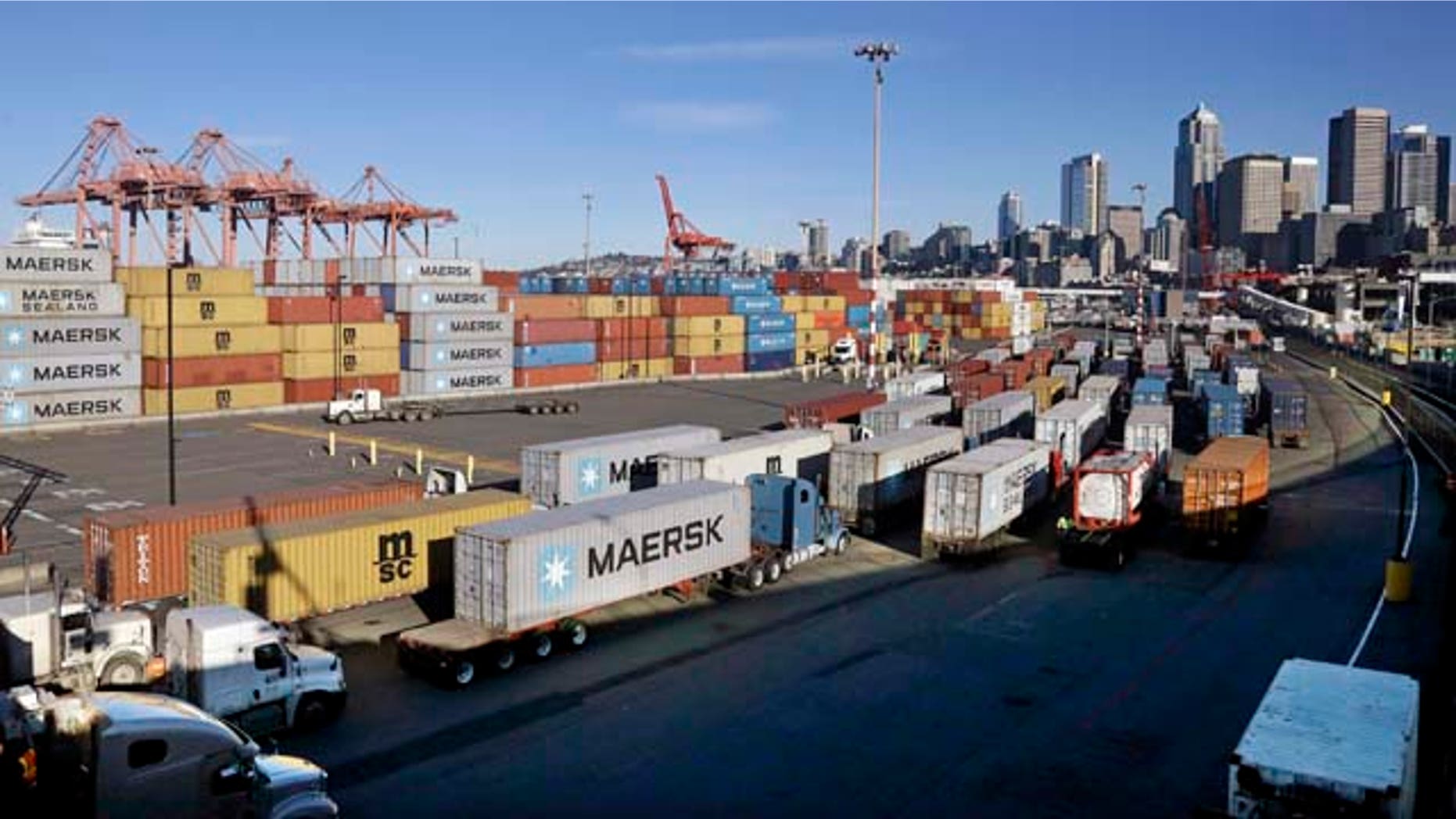 Feb. 17, 2015: Loaded container trucks line-up at a gate at the Port of Seattle. (AP Photo/Elaine Thompson)