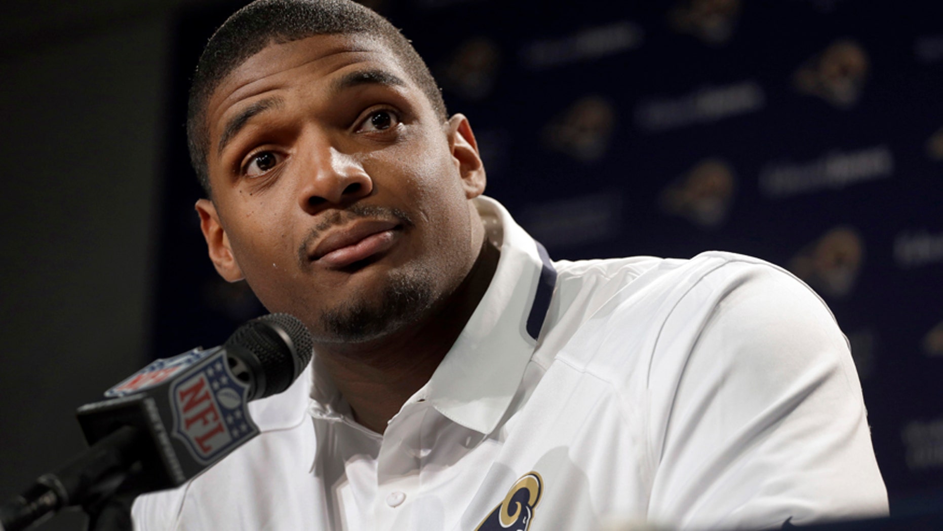 St. Louis Rams seventh-round draft pick Michael Sam listens to a question during a news conference at the NFL football team's practice facility Tuesday, May 13, 2014, in St. Louis.