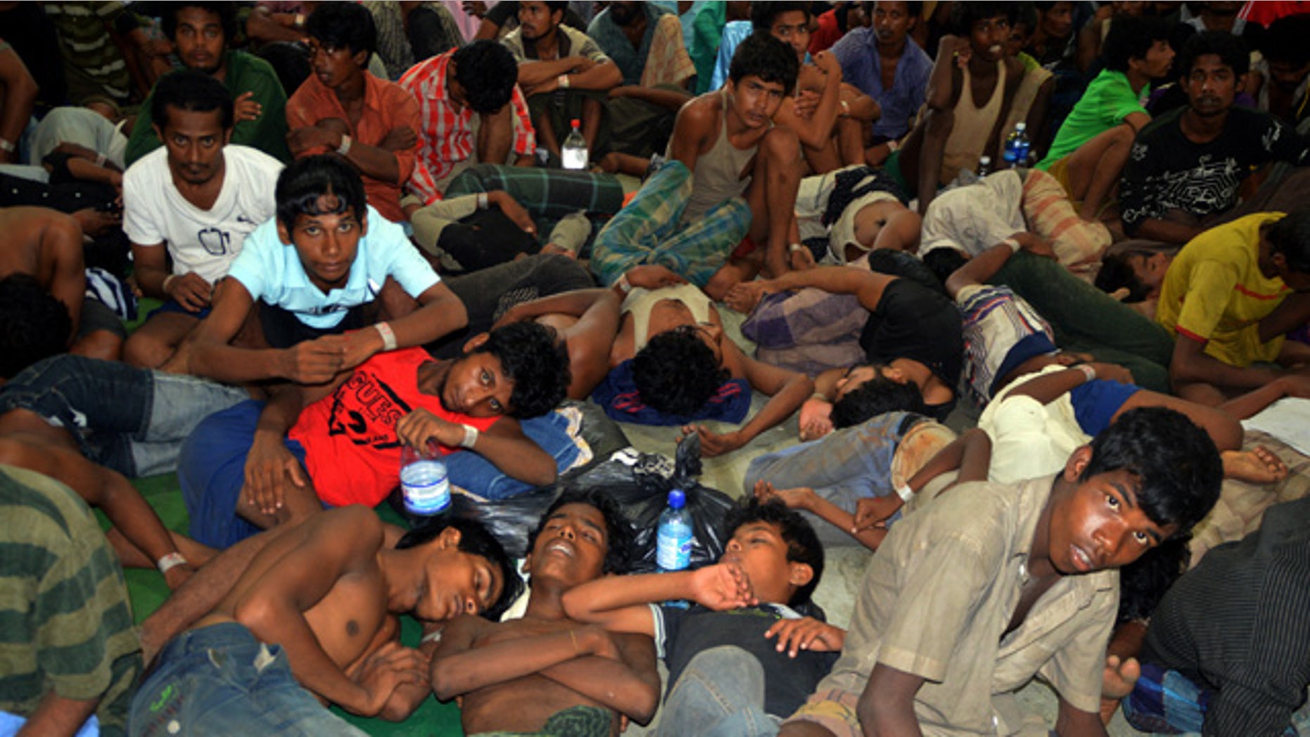 May 11, 2015: Illegal immigrants from Burma and Bangladesh arrive at the Langkawi police station's multipurpose hall in Langkawi, Malaysia. (AP Photo/Hamzah Osman)