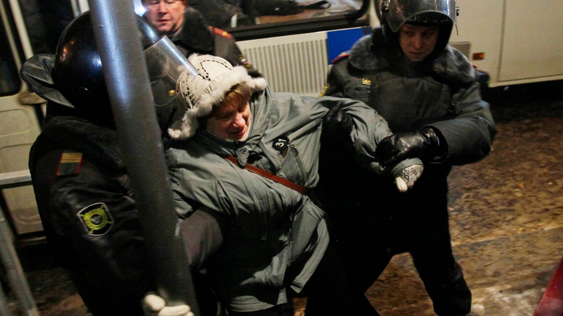 Riot police officers detain a protester during a rally in central Moscow, Russia, Friday, Dec. 31, 2010. The Russian opposition protests on the 31st of each month are a nod to the 31st article of the Russian constitution, which guarantees the right of assembly.