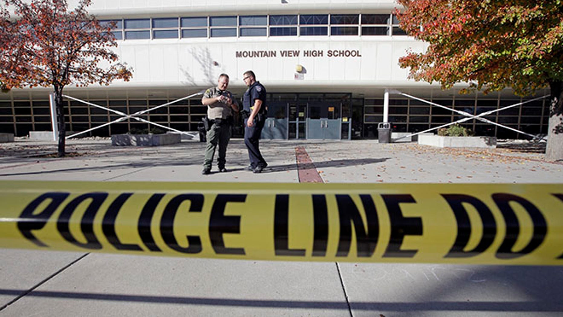 Police stand outside Mountain View High School after several students were stabbed inside the high school Tuesday, Nov. 15, 2016, in Orem, Utah Police say a 16-year-old boy was taken into custody after the stabbings. (AP Photo/Rick Bowmer)