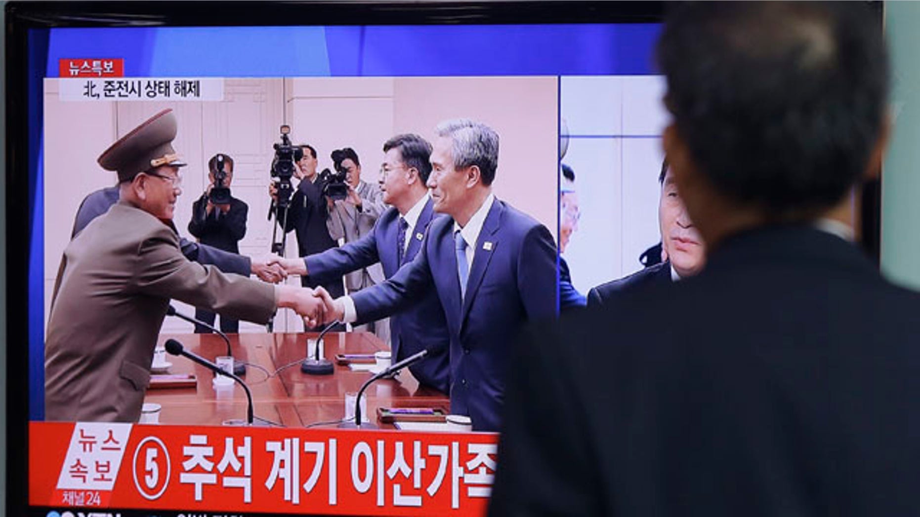 Aug. 25, 2015: A man at the Seoul Railway Station watches a TV news program reporting South Korea and North Korea reached an agreement. After 40-plus-hours of talks, the two Koreas on Tuesday pulled back from the brink with an accord that allows both sides to save face and avert the bloodshed they've been threatening each other with for weeks. (AP Photo/Ahn Young-joon)