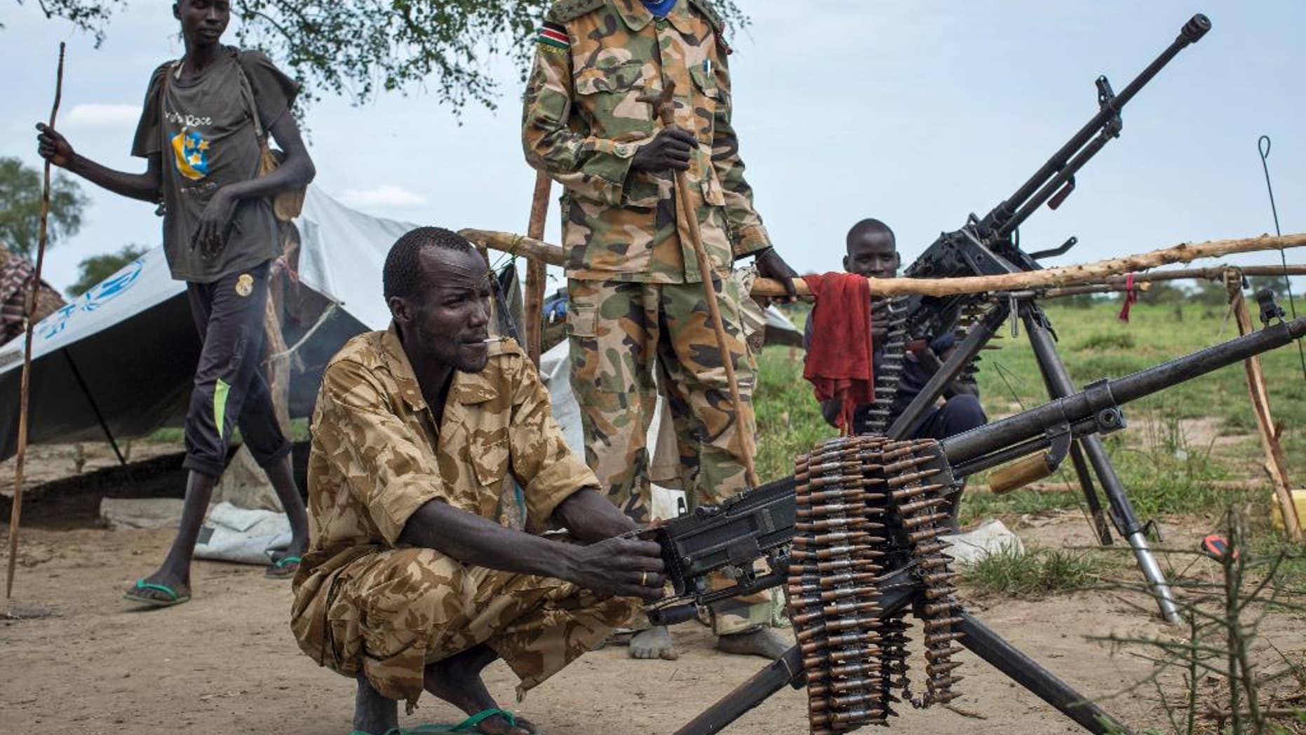 Rebel soldiers guard the village of Majieng, about 6km from the town of Bentiu, in South Sudan Saturday, Sept. 20, 2014. Seyoum Mesfin, the chairman of the South Sudan mediation process said Saturday there is renewed fighting in South Sudan between government and rebel troops and that it is a purposeful act aimed at derailing the next phase of the peace process. (AP Photo/Matthew Abbott)
