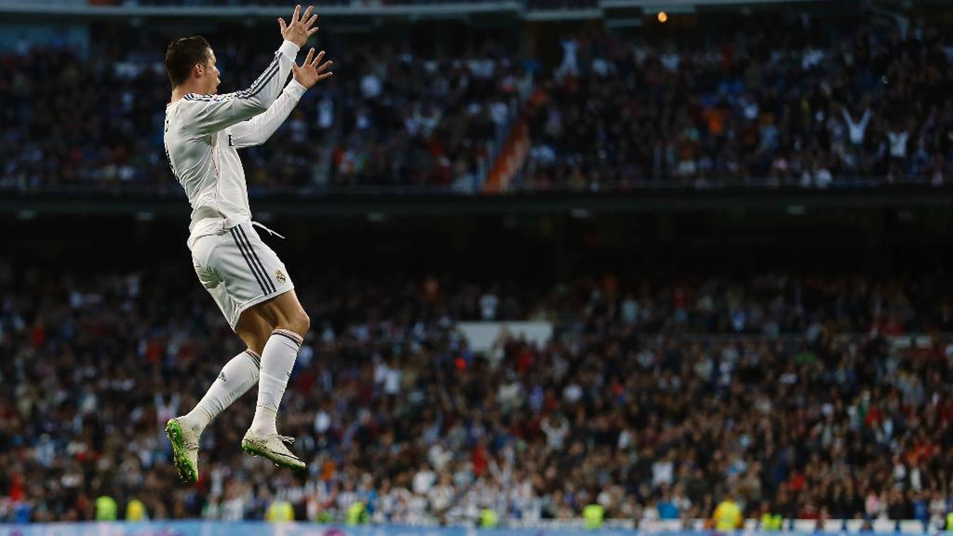 Real's Cristiano Ronaldo celebrates his goal during a Spanish La Liga soccer match between Real Madrid and Levante at the Santiago Bernabeu stadium in Madrid, Spain, Sunday, March 9, 2014. (AP Photo/Andres Kudacki)