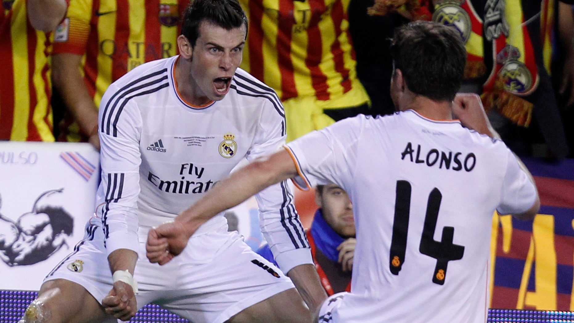 Real's Gareth Bale, left celebrates with Xabi Alonso on Wednesday, April 16, 2014.