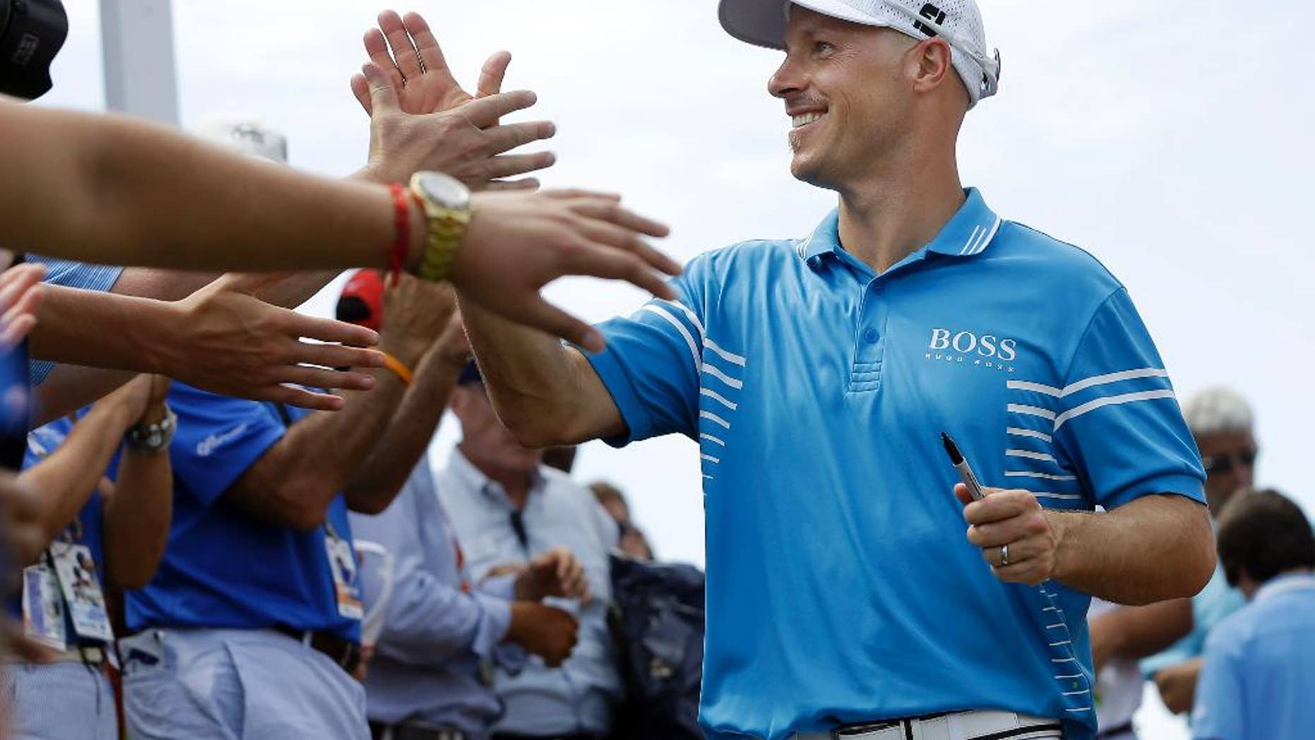 Ben Crane is congratulated after winning the St. Jude Classic golf tournament Sunday, June 8, 2014, in Memphis, Tenn. Crane won the tournament with a score of 10-under 270.(AP Photo/Mark Humphrey)