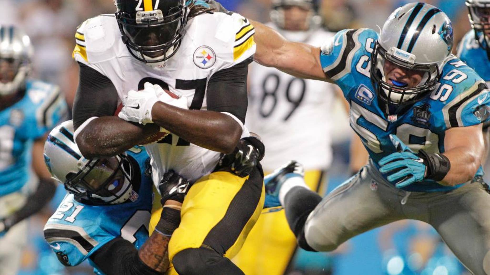 Pittsburgh Steelers' LeGarrette Blount (27) runs between Carolina Panthers' Robert Golden (21) and Luke Kuechly (59) for a touchdown during the second half of an NFL football game in Charlotte, N.C., Sunday, Sept. 21, 2014. The Steelers won 37-19. (AP Photo/Bob Leverone)