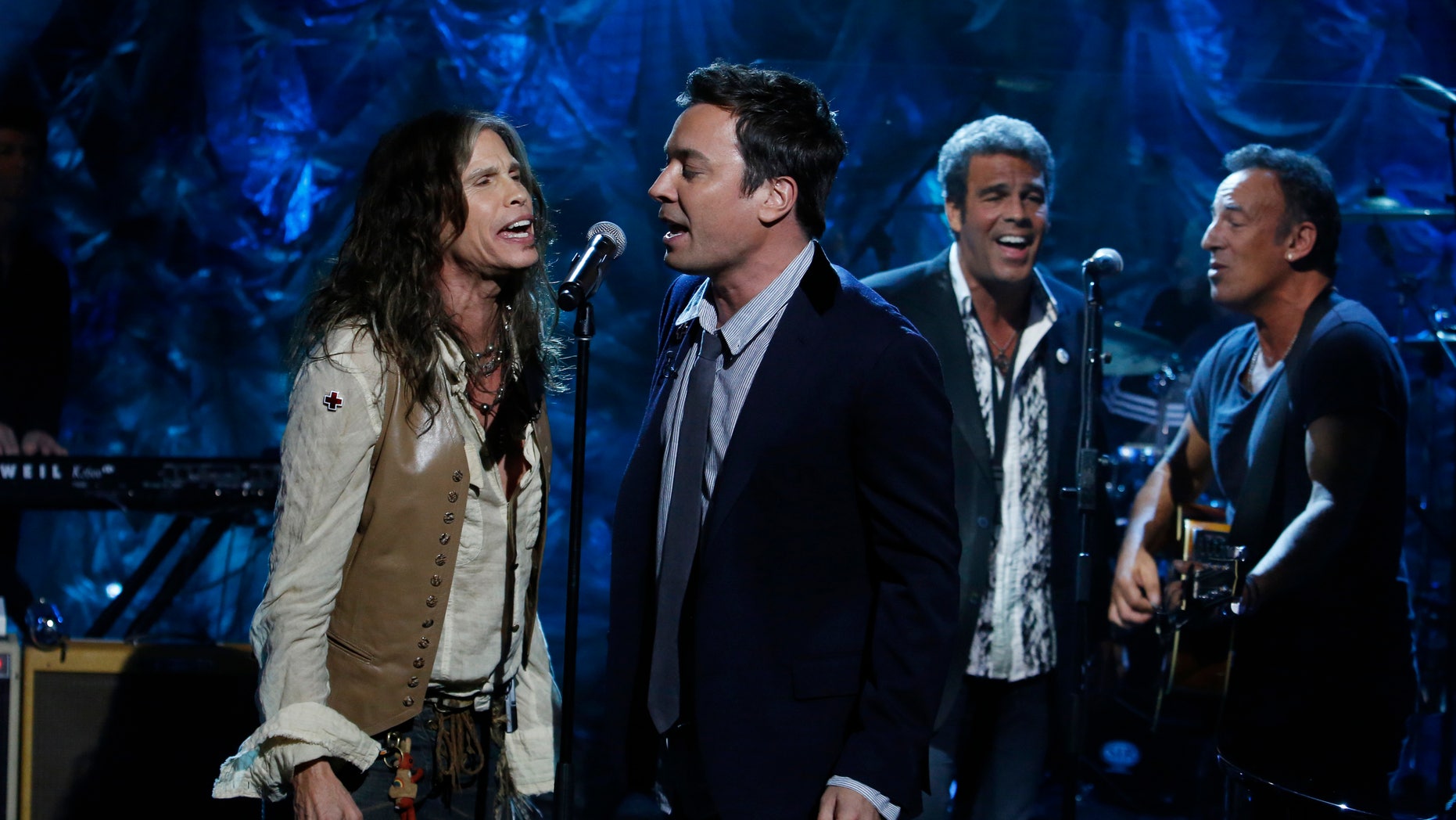 In this photo provided by NBC, from left, Steven Tyler, Jimmy Fallon, Mark Rivera, and Bruce Springsteen, perform during "Hurricane Sandy: Coming Together" Friday, Nov. 2, 2012, in New York. Hosted by Matt Lauer, the event is heavy on stars identified with New Jersey and the New York metropolitan area, which took the brunt of this week's deadly storm. (AP Photo/NBC, Heidi Gutman)