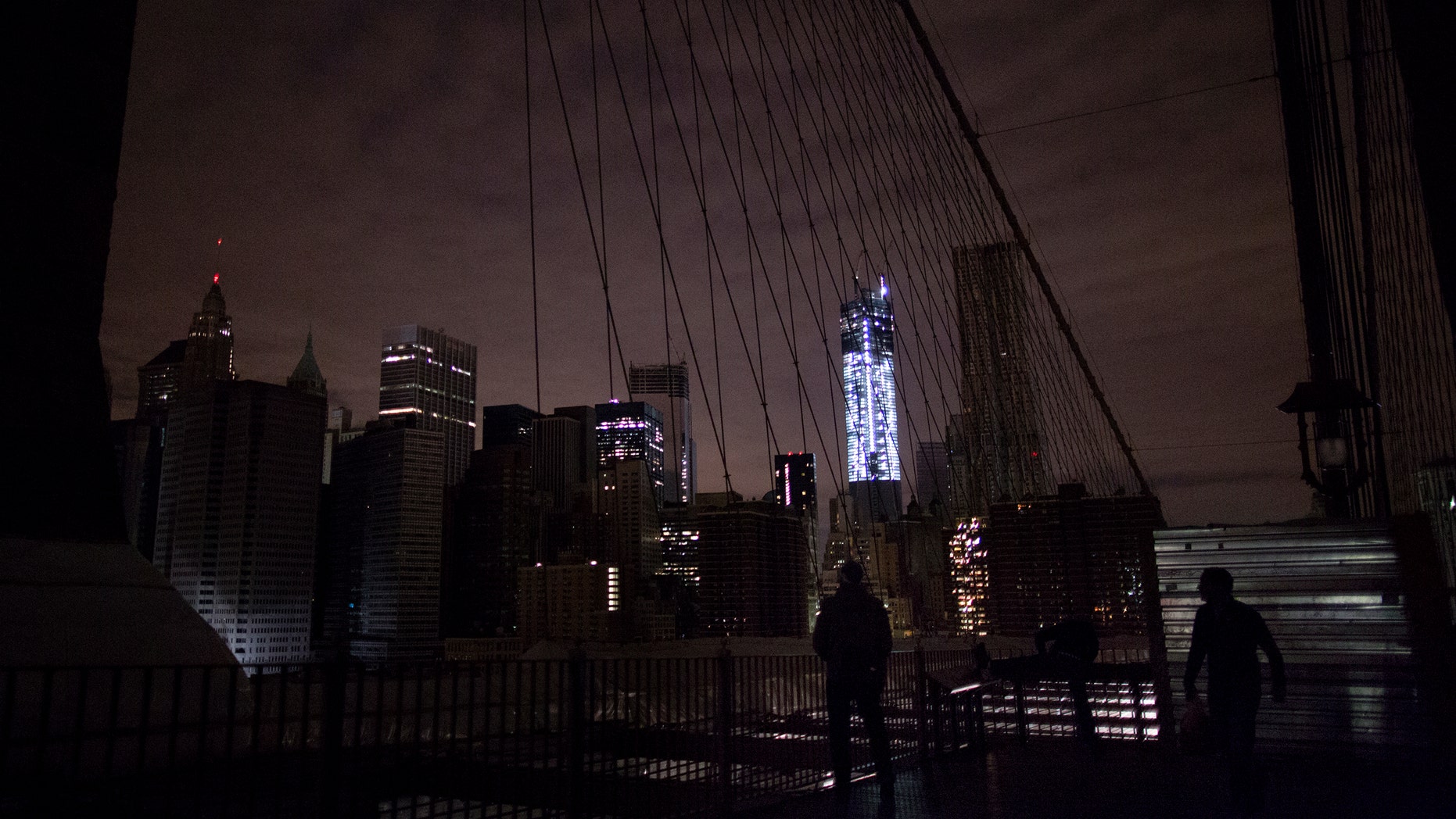 Much of lower Manhattan remains dark, as viewed from the darkened Manhattan side of the pedestrian walkway of the Brooklyn Bridge, Thursday, Nov. 1, 2012 in New York. In the wake of superstorm Sandy, power outages still plague much of the New York area. (AP Photo/Craig Ruttle)
