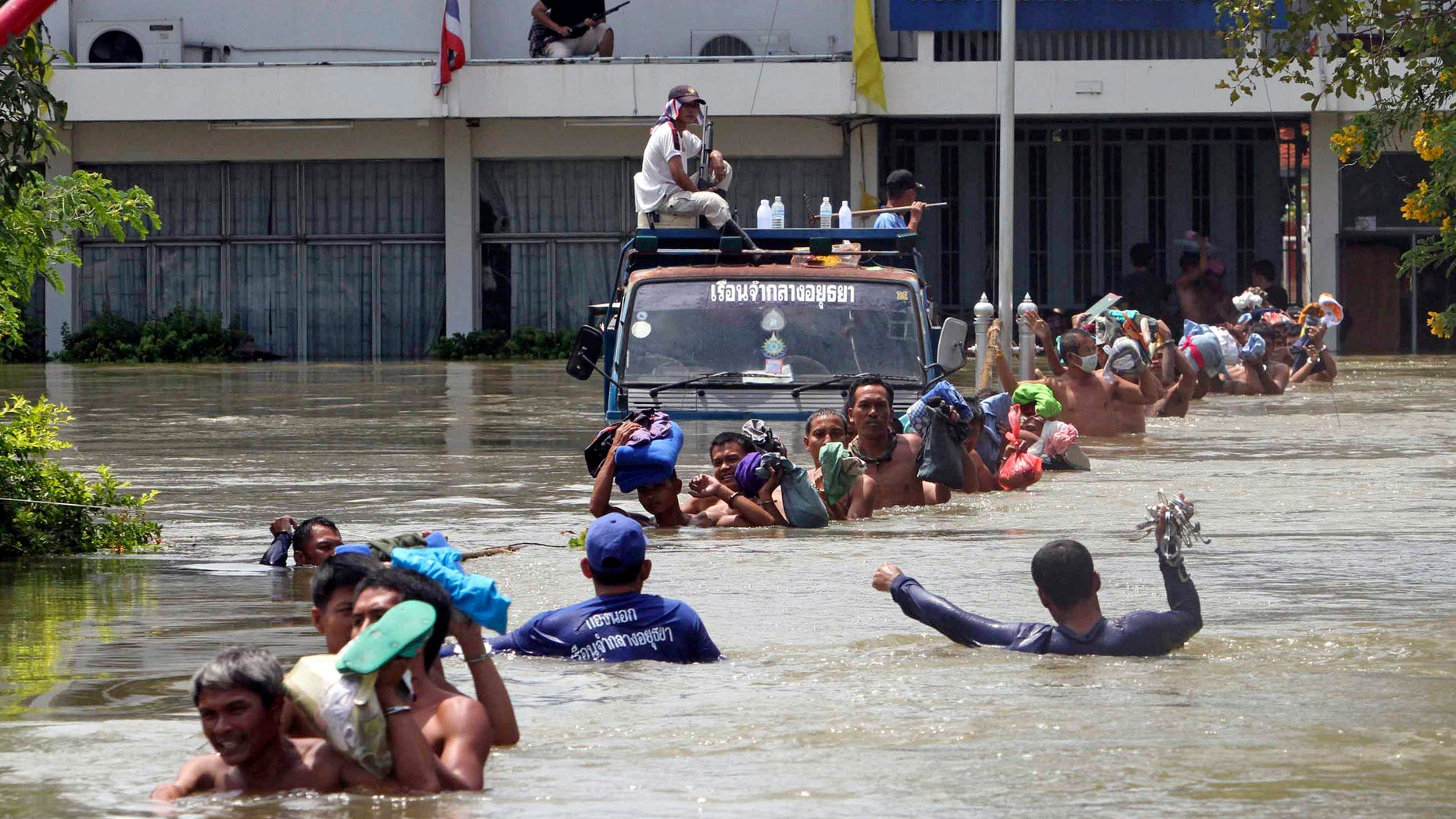 Prisoners at Ayutthaya prison wade in line in a chest-deep flood water to board a bus during an evacuation after flood water hit Ayutthaya province, central Thailand Thursday, Oct. 6, 2011. Nearly 5,000 prisoners in this province were evacuated to the prisons in nearby provinces of Nonthaburi and Lopburi. Flooding in Ayutthaya, the old Thai capital, could threaten ancient Buddhist temples and have alerted residents there to be ready to evacuate as a tropical storm approaches the region.