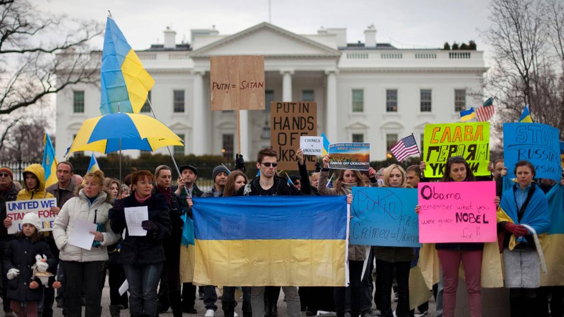 Demonstrators gather outside the White House in Washington, Saturday, March 1, 2014. Russian troops took over Crimea as the parliament in Moscow gave President Vladimir Putin a green light Saturday to use the military to protect Russian interests in Ukraine. (AP Photo/Pablo Martinez Monsivais)