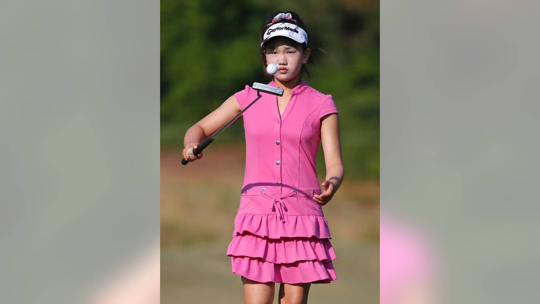 Lucy Li bounces the ball off of her putter on the second green during a practice round for the U.S. Women's Open golf tournament in Pinehurst, N.C., Wednesday, June 18, 2014. The sixth-grader from California is the youngest qualifier in the history of the U.S. Women's Open. (AP Photo/John Bazemore)