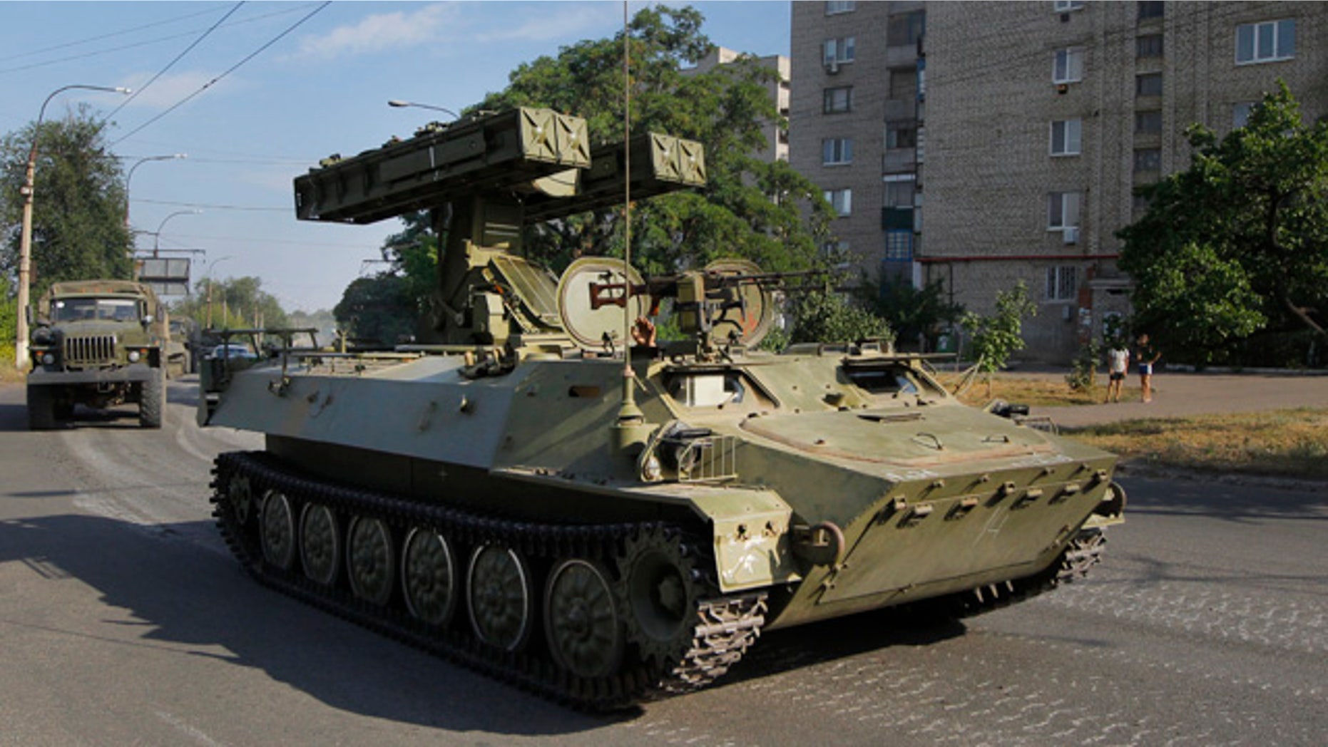 FILE - This is a Sunday, Aug. 17, 2014 file photo of a pro-Russian missile launcher as it drives in the town of Krasnodon. (AP Photo/Sergei Grits, File)