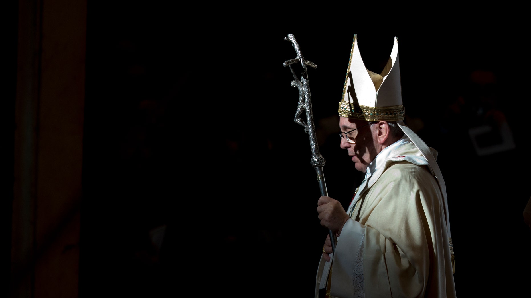 Pope Francis holds the pastoral staff as he leaves after celebrating a Mass in St. Peter's Basilica, at the Vatican, to mark Epiphany, Monday, Jan. 6, 2014. The Epiphany day, is a joyous day for Catholics in which they recall the journey of the Three Kings, or Magi, to pay homage to Baby Jesus. (AP Photo/Andrew Medichini)