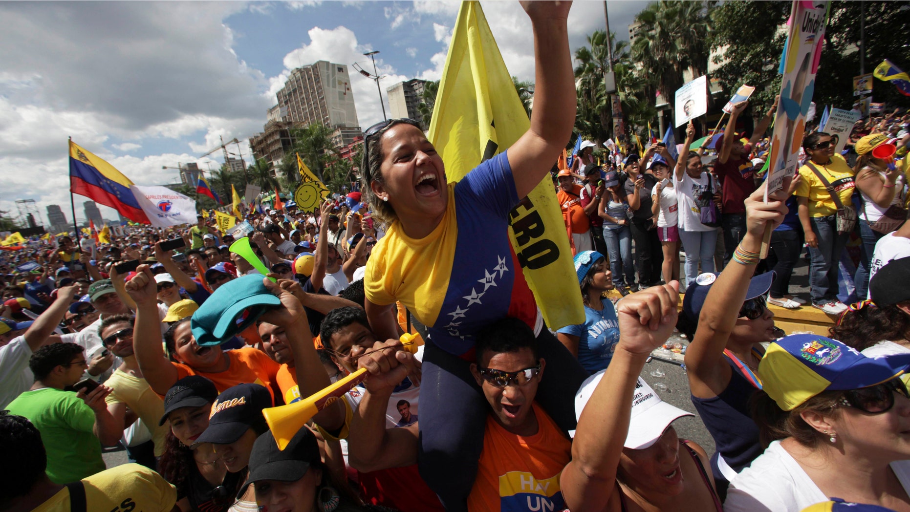 Supporters of opposition presidential candidate Henrique Capriles cheer during a campaign rally in Caracas, Venezuela, Sunday, Sept. 30, 2012. (AP Photo/Fernando Llano)