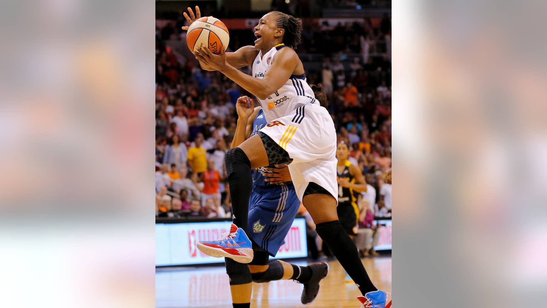 FILE - In this July 19, 2014, file photo, East's Tamika Catchings, of the Indiana Fever, scores the game winning basket during the overtime period of the WNBA All-Star basketball game in Phoenix. Three-time Olympic gold medalist Tamika Catchings says she will retire after the 2016 Rio Games. The Indiana Fever star confirmed Friday, Oct. 3, 2014, in an email to The Associated Press that she will call it quits after the 2016 Olympics, but plans to play two more WNBA seasons. (AP Photo/Matt York, File)