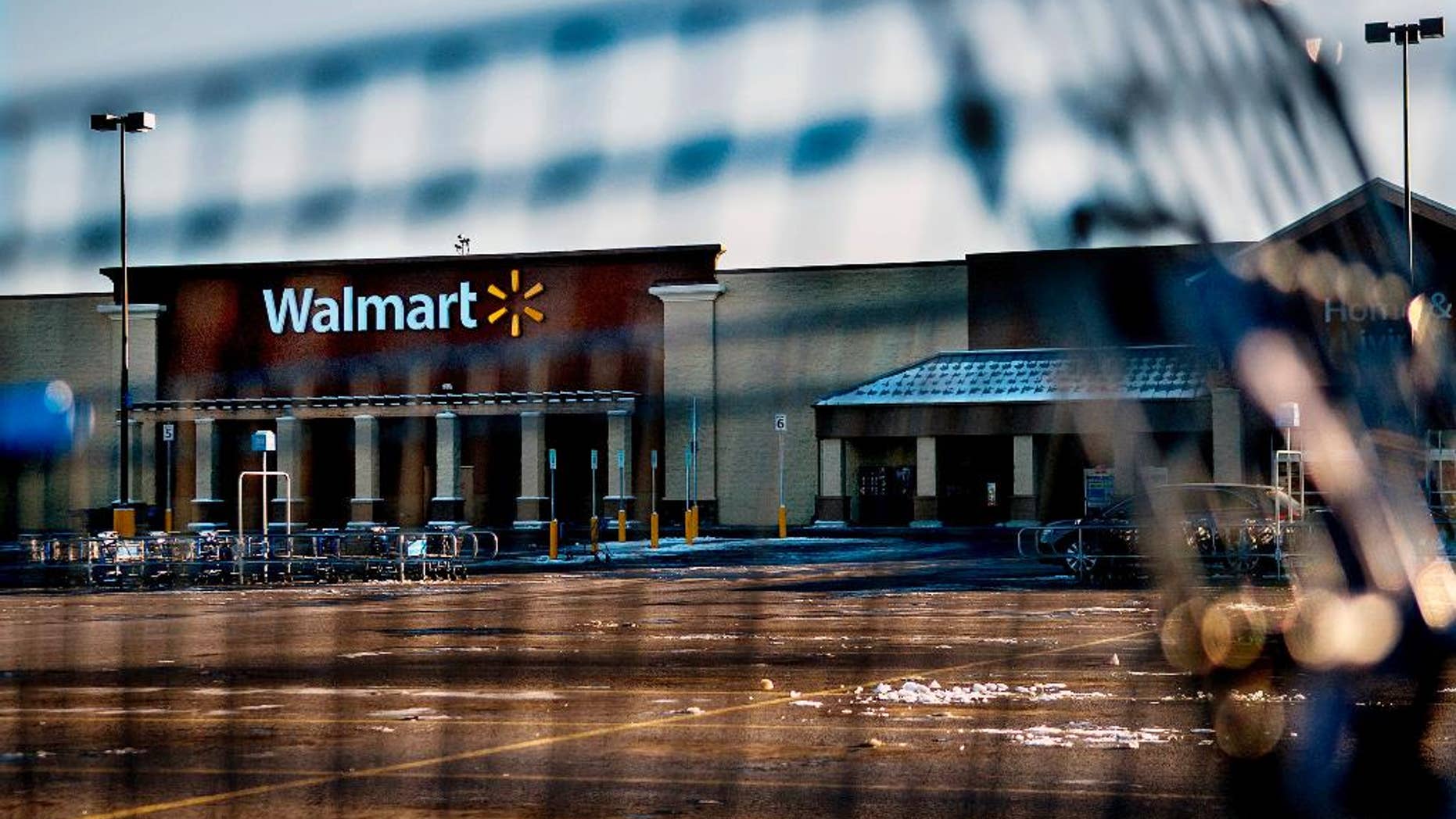 This photo shows Wal-Mart with a shopping cart in the foreground in Hayden, Idaho, Tuesday, Dec. 30, 2014. A 2-year-old boy accidentally shot and killed his mother after he reached into her purse at the northern Idaho Wal-Mart and her concealed gun fired, authorities said Tuesday. (AP Photo/The Spokesman-Review, Kathy Plonka) COEUR D'ALENE PRESS OUT