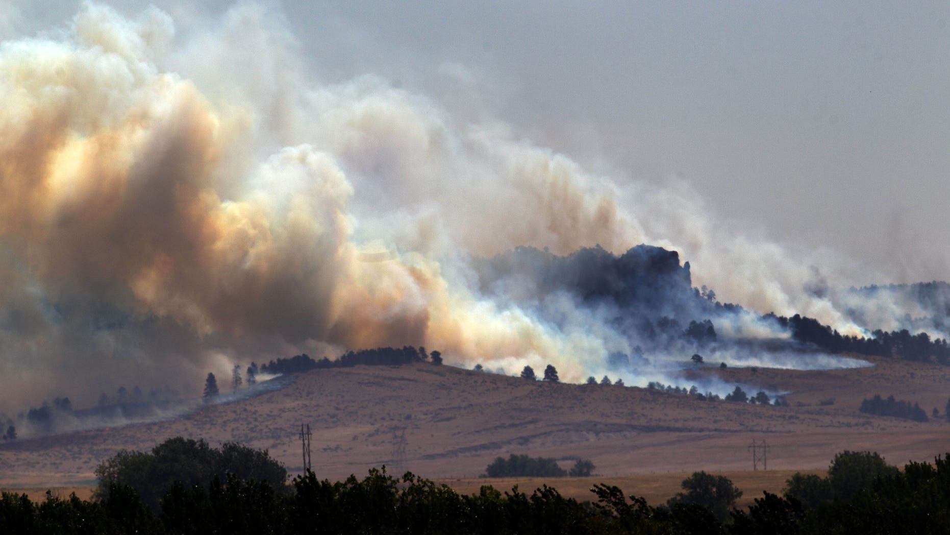 In this Saturday, Sept. 1, 2012 photo, smoke plumes rise from the West Ash Creek wildfire near Crawford Neb. The blaze is one of three wildfires burning in Nebraska and South Dakota, started earlier in the week by lightning. (AP Photo/Omaha World-Herald, Mark Davis) MAGS OUT; ALL NEBRASKA LOCAL BROADCAST TV OUT