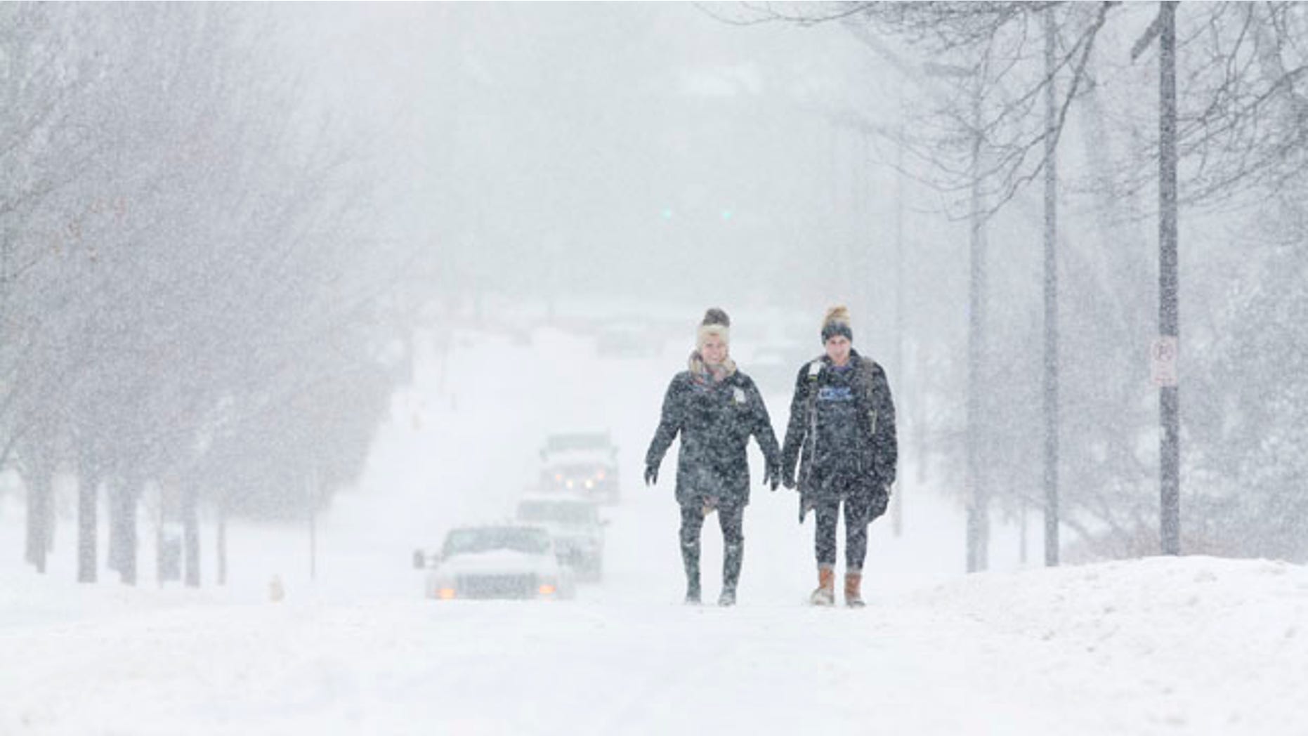 Feb. 16, 2015: University of Kentucky students Courtney Wiseman, left, and Abby Lerner walk home after studying on campus even as classes were canceled for the day in Lexington. (AP Photo/David Stephenson)