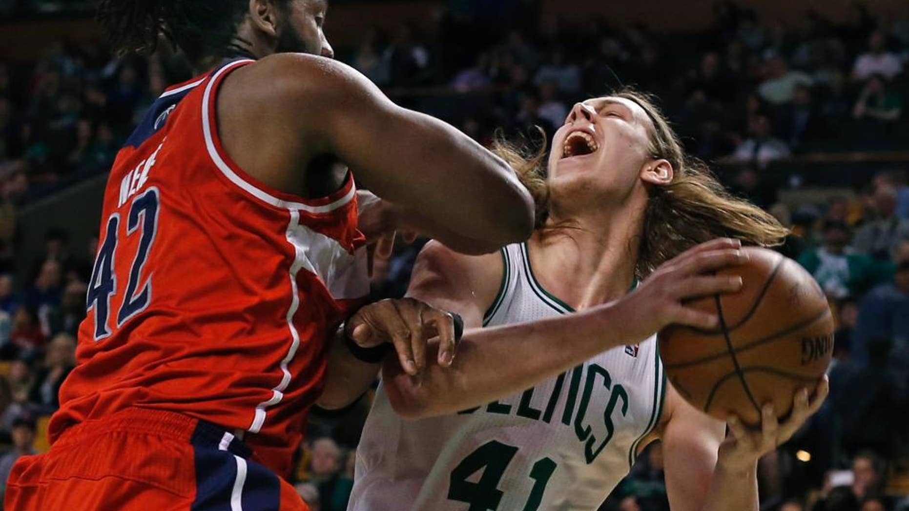 Boston Celtics center Kelly Olynyk (41) goes up to shoot against Washington Wizards forward Nene Hilario (42) during the second half of an NBA basketball game in Boston, Wednesday, April 16, 2014. The Wizards won 118-102. (AP Photo/Elise Amendola)
