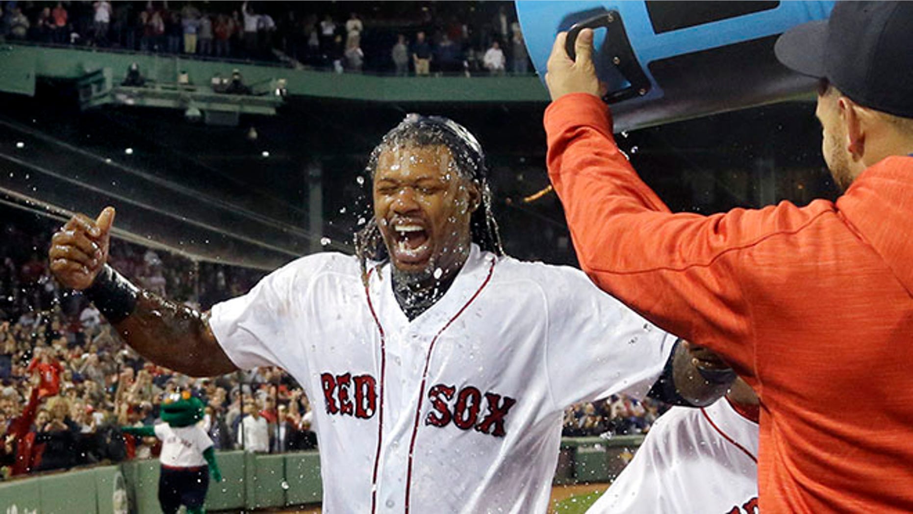Boston Red Sox's Hanley Ramirez is doused by teammates on Thursday, Sept. 15, 2016, in Boston.