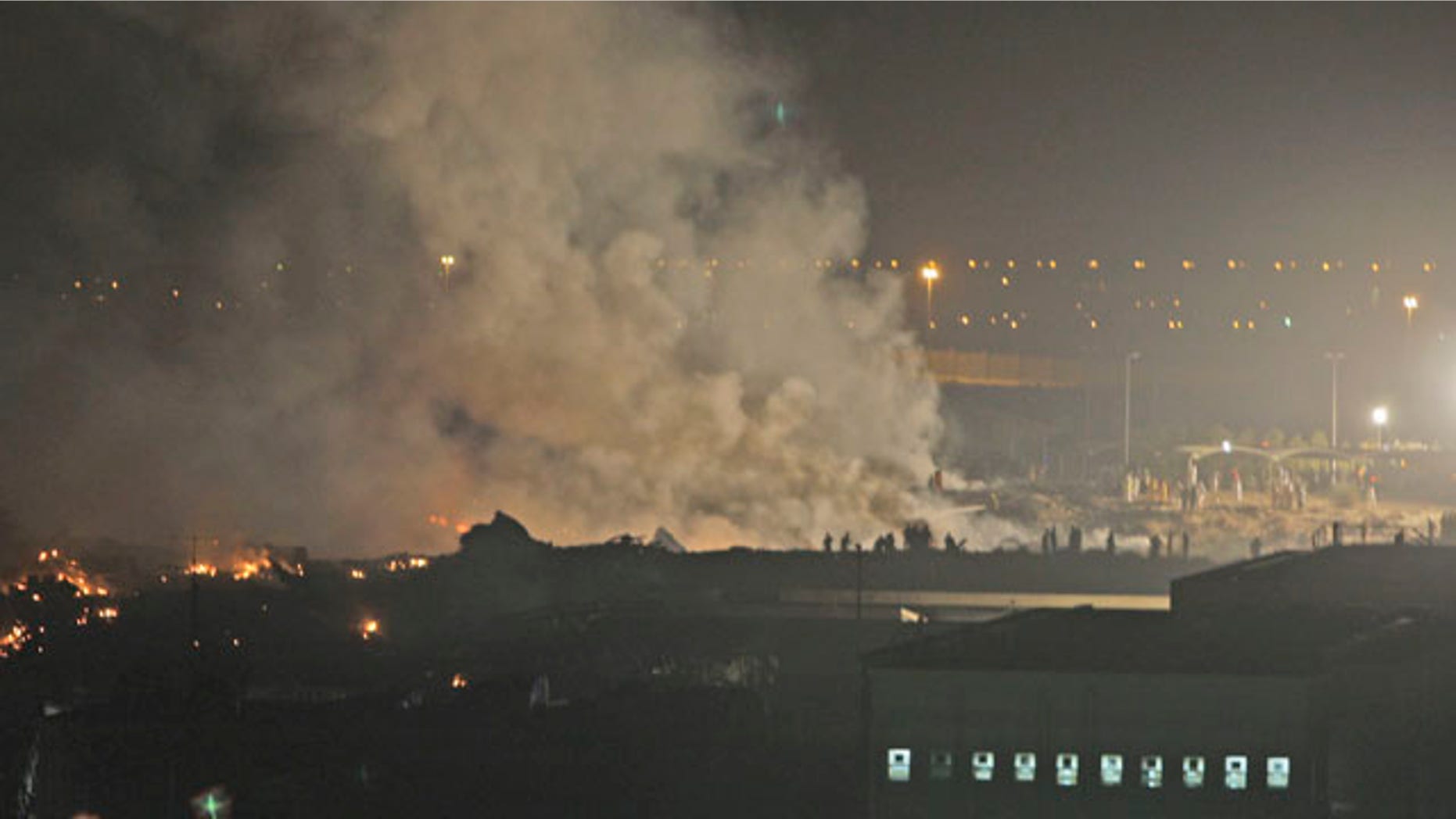 Sept. 3: Smoke rises from the site of a cargo plane crash in Dubai, United Arab Emirates. Officials say a UPS cargo plane with two crew members on board has crashed shortly after takeoff outside Dubai.
