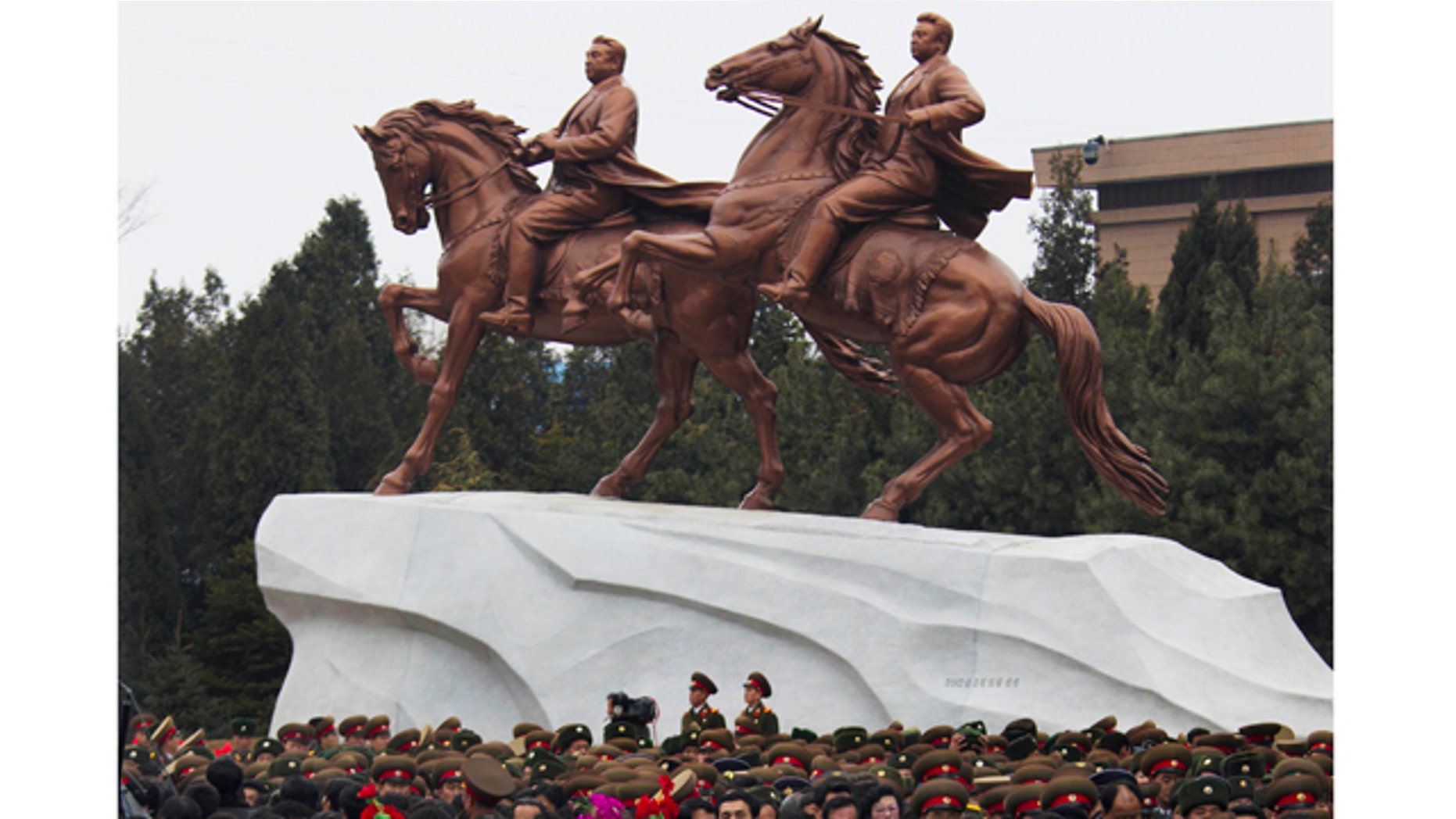 Feb. 14,2012- North Koreans leave the grounds of the Mansudae Art Studio in Pyongyang after watching the unveiling of a new bronze statue depicting the late leader Kim Jong Il and his father Kim Il Sung. As North Koreans prepare for what would have been the 70th birthday of late leader Kim Jong Il this week, the country's state media have gone to great lengths to build up the man who led the nation for 17 years until his death in December.