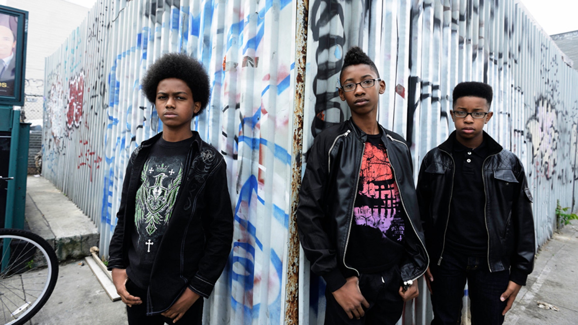 This image released by Penguin Young Readers Group shows, from left, Malcolm Brickhouse, Alec Atkins and Jarad Dawkins of the teen metal band Unlocking the Truth.