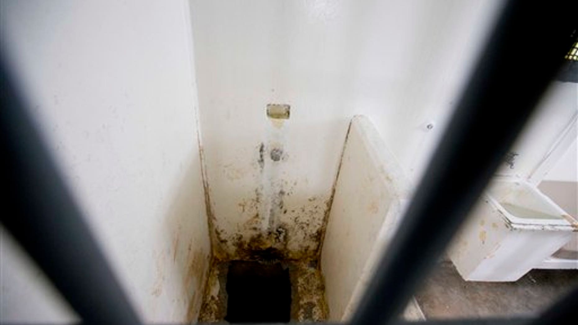 This photo shows the shower area and opening to a tunnel, where authorities claim drug lord Joaquin "El Chapo" Guzman, slipped into the tunnel to escape from his prison cell, at the Altiplano maximum security prison, in Almoloya, west of Mexico City, Wednesday, July 15, 2015. Experts have said the tunnel would have been more than a year in planning and building. The digging would have caused noise. The entrance was in a place beyond the view of security cameras at Mexico's toughest prison. They also said it was clear the escape by Mexico's most powerful drug lord must have involved inside help on a grand scale. (AP Photo/Eduardo Verdugo)