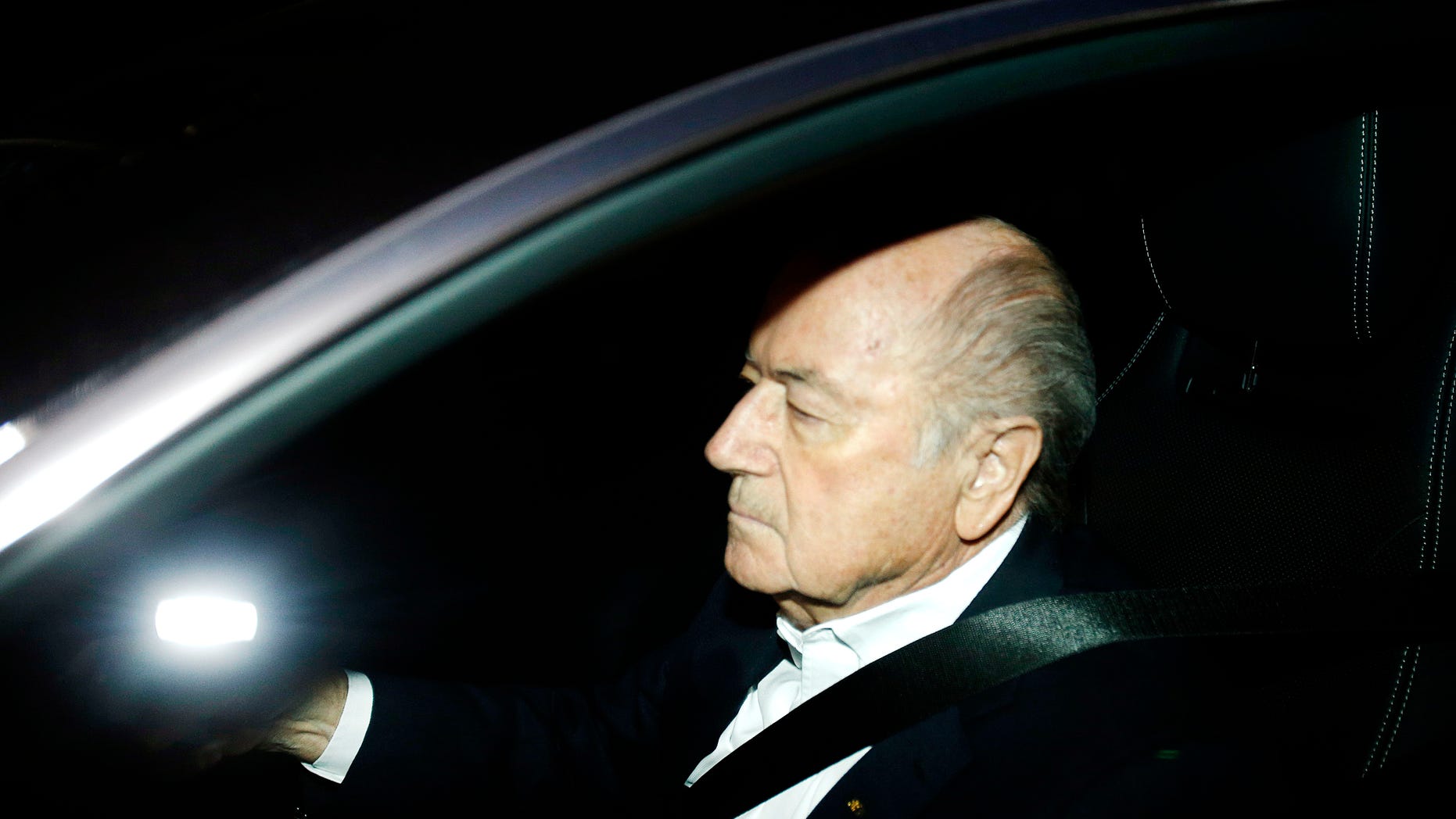 FILE - In this Sept. 29, 2015 file photo FIFA President Sepp Blatter drives his car into the garage of the FIFA headquarters on his way to work in Zurich, Switzerland (AP Photo/Michael Probst, file)