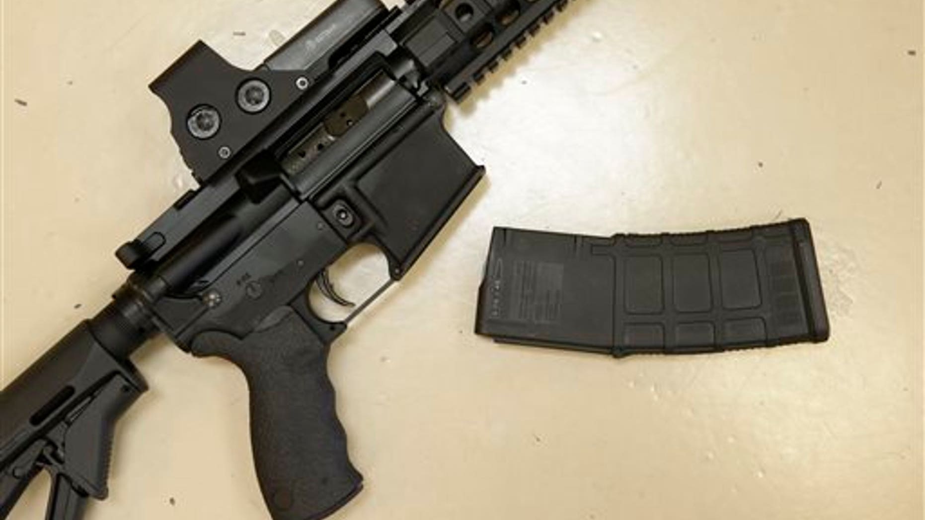 In this file photo, a custom-made semi-automatic hunting rifle with a high-capacity detachable magazine is displayed at TDS Guns in Rocklin, Calif. Calif. (AP Photo/Rich Pedroncelli)