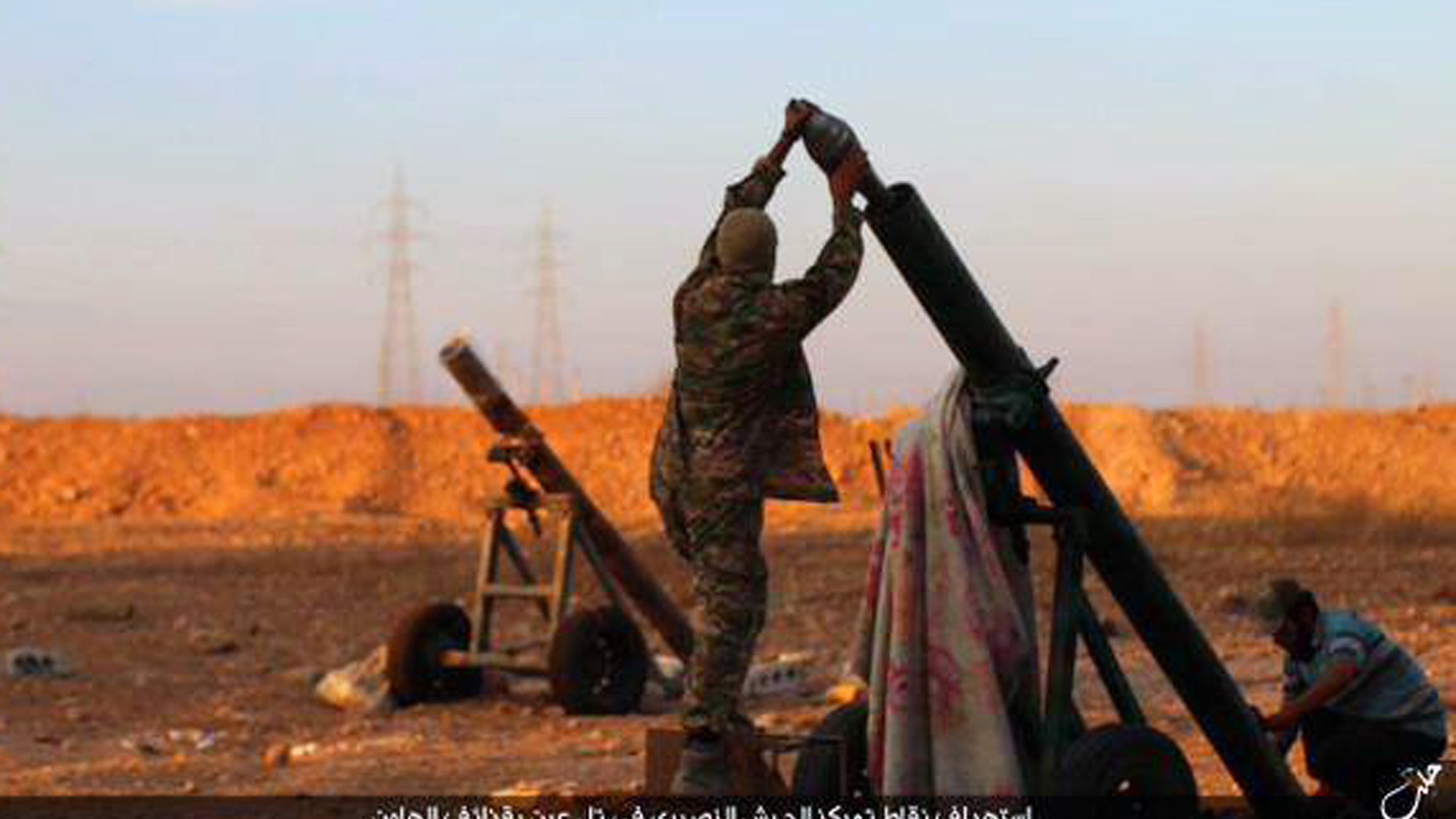 Oct. 8, 2015 - ISIS militants preparing to fire a mortar towards Syrian government forces positions at Tal Arn in Aleppo province, Syria. ISIS seized several villages from rival insurgents north of Aleppo, in a surprise attack that came despite intensive Russian airstrikes that Moscow insists are targeting the extremist group, activists said.
