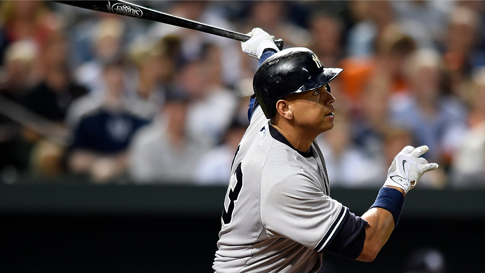 New York Yankees' Alex Rodriguez follows through on a two-run home run against the Baltimore Orioles during the sixth inning of a baseball game Saturday, June 13, 2015, in Baltimore. (AP Photo/Gail Burton)