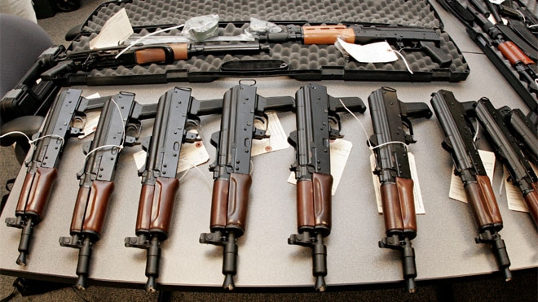 This 2008 file photo shows weapons seized by the Bureau of Alcohol, Tobacco, Firearms and Explosives (ATF), and laid out on a table at the bureau's Arizona headquarters in Phoenix.
