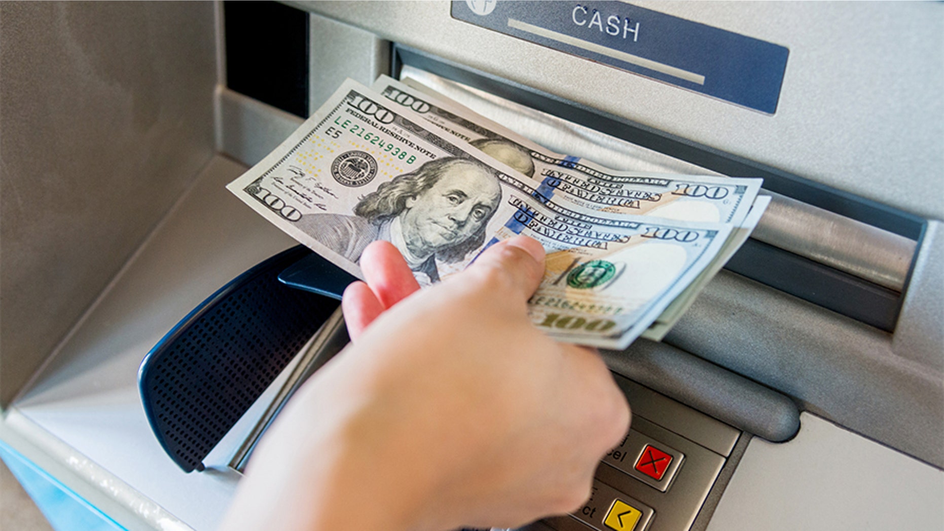 A Kansas woman (not pictured) is accused of taking advantage of a faulty ATM that was dispensing $100 bills instead of $5 bills.