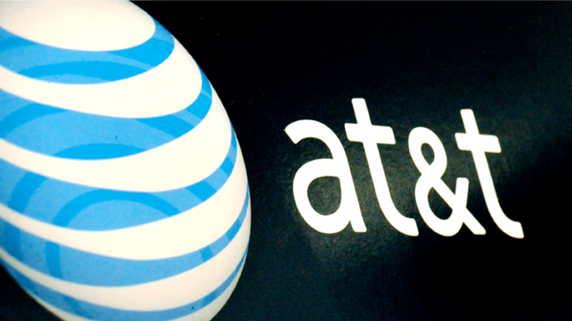The AT&T logo is on display at a RadioShack store in Gloucester, Mass.