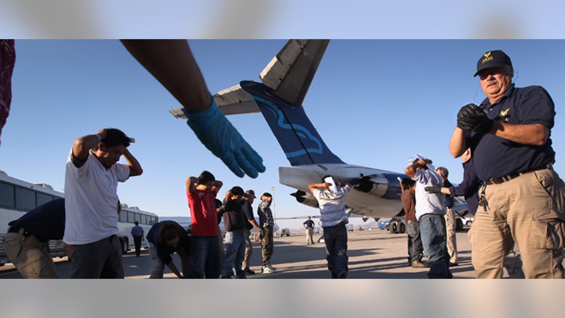MESA, AZ - JUNE 24: Undocumented Guatemalan immigrants are body searched before boarding a deportation flight to Guatemala City, Guatemala at Phoenix-Mesa Gateway Airport on June 24, 2011 in Mesa, Arizona. The U.S. Immigration and Customs Enforcement agency, ICE, repatriates thousands of undocumented Guatemalans monthly, many of whom are caught in the controversial "Secure Communities" data-sharing program which puts local police on the frontlines of national immigration enforcement. ICE recently announced a set of adjustments to the federal program after many local communities and some states, including New York, insisted on opting out, saying immigrants were being deported for minor offenses such as traffic violations. Guatemala ranks only second to Mexico in the number of illegal immigrants deported from the United States. (Photo by John Moore/Getty Images)