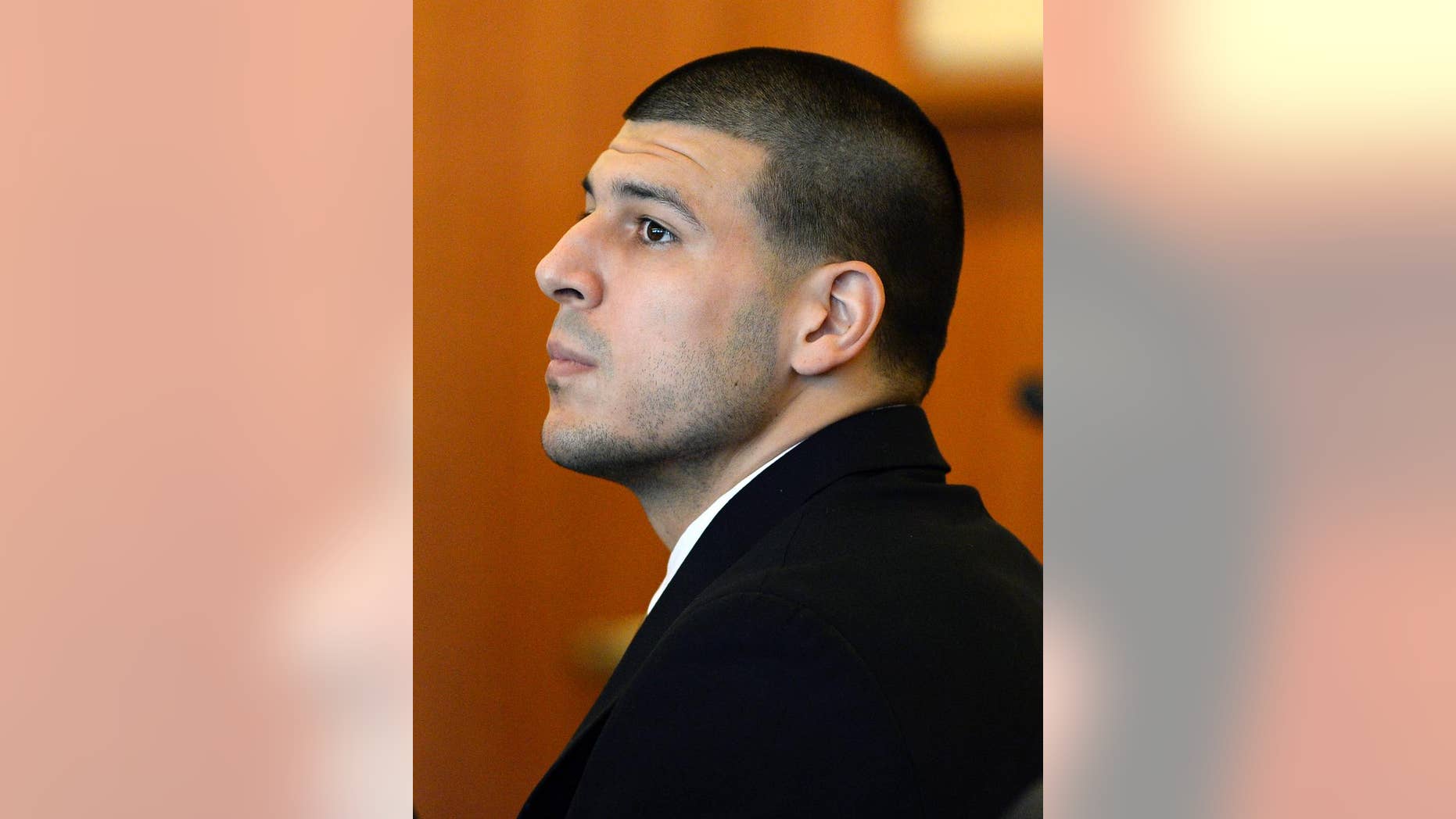 FILE - In this July 22, 2014, file photo, former New England Patriots' Aaron Hernandez watches during a hearing in Bristol County Superior Court in Fall River, Mass. Hernandez is charged with killing Odin Lloyd of Boston, whose body was found in an industrial park near Hernandez’s home in North Attleborough in June 2013. During a hearing Monday, Aug. 11, 2014, Judge E. Susan Garsh took under advisement a motion by his defense to suppress evidence from some electronic devices seized from the former NFL football player's home during the investigation. (AP Photo/CJ Gunther, Pool, File)