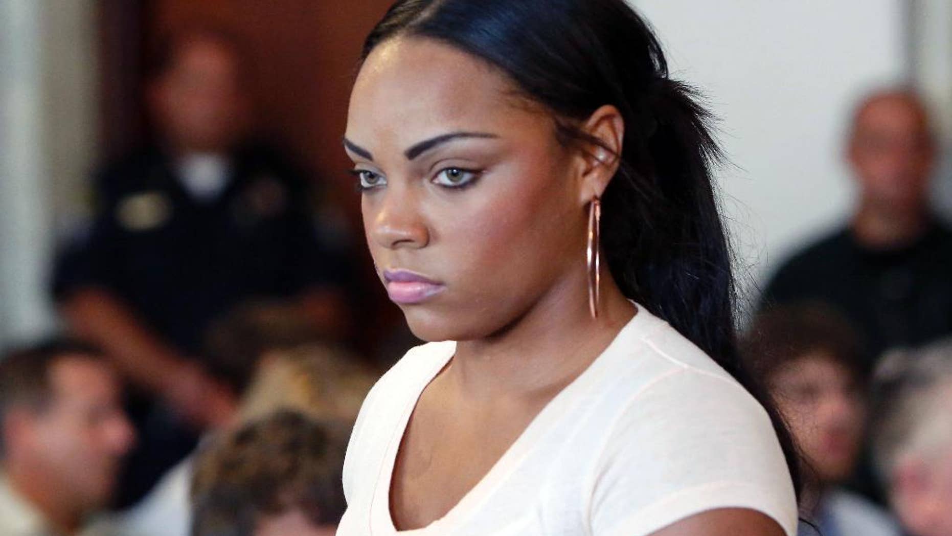FILE - In this July 24, 2013, file photo, Shayanna Jenkins, fiancee of former New England Patriots NFL football player Aaron Hernandez, arrives at a hearing for Hernandez at Attleboro District Court in Attleboro, Mass. Her lawyers filed a motion Thursday, Aug. 14, 2014, in county court in Fall River, Mass., seeking to have perjury charges dismissed. She is charged with lying to a grand jury investigating the killing of Odin Lloyd, a semi-professional football player who was dating her' sister. Hernandez faces three murder charges, including in Lloyd's killing. (AP Photo/Bizuayehu Tesfaye, File)