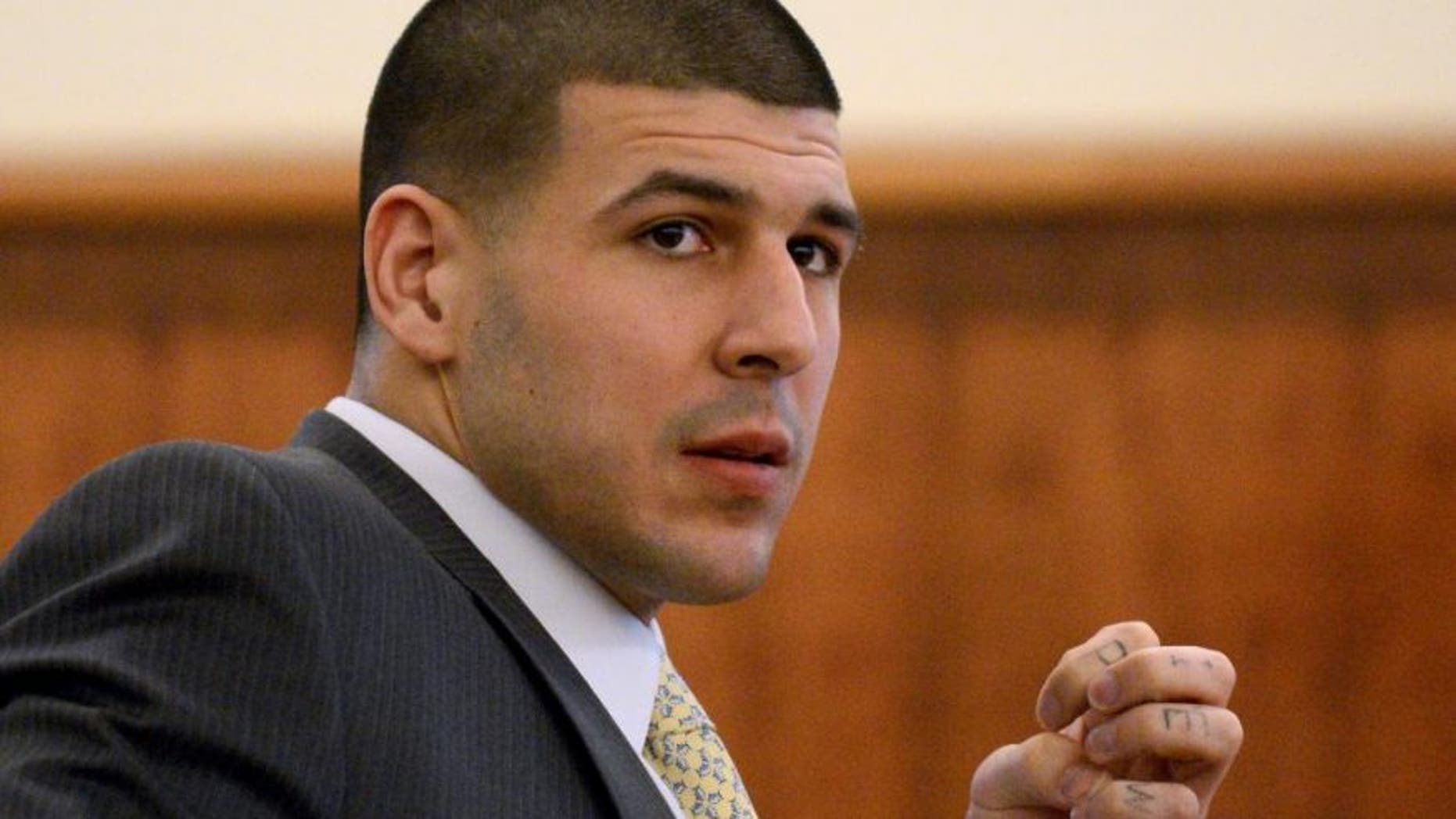 Former New England Patriots football player Aaron Hernandez watches during his murder trial Friday, March 6, 2015, in Fall River, Mass. Hernandez is charged with killing semiprofessional football player Odin Lloyd.