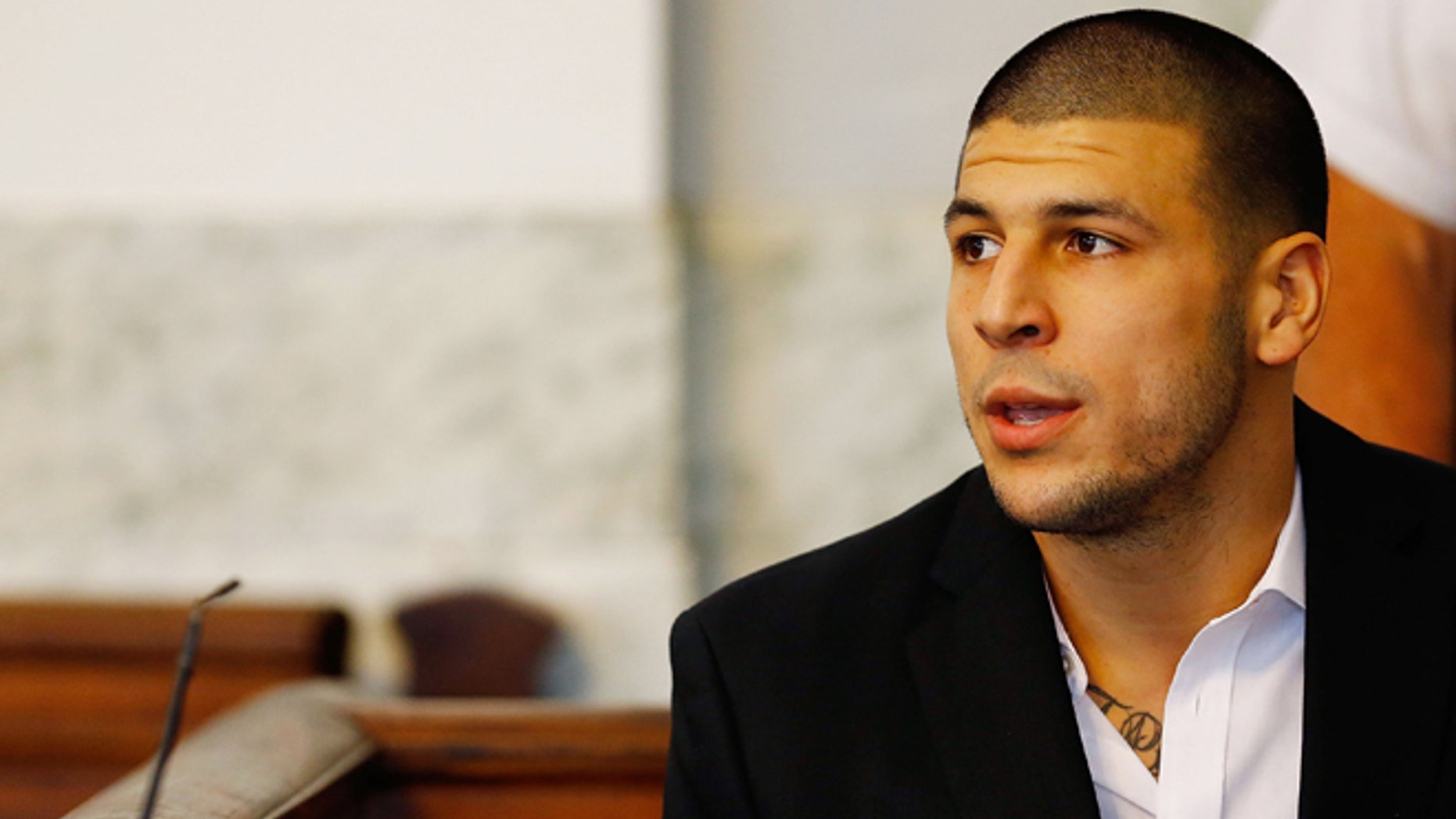 NORTH ATTLEBORO, MA - AUGUST 22: Aaron Hernandez sits in the courtroom of the Attleboro District Court during his hearing on August 22, 2013 in North Attleboro, Massachusetts. Former New England Patriot Aaron Hernandez has been indicted on a first-degree murder charge for the death of Odin Lloyd. (Photo by Jared Wickerham/Getty Images)